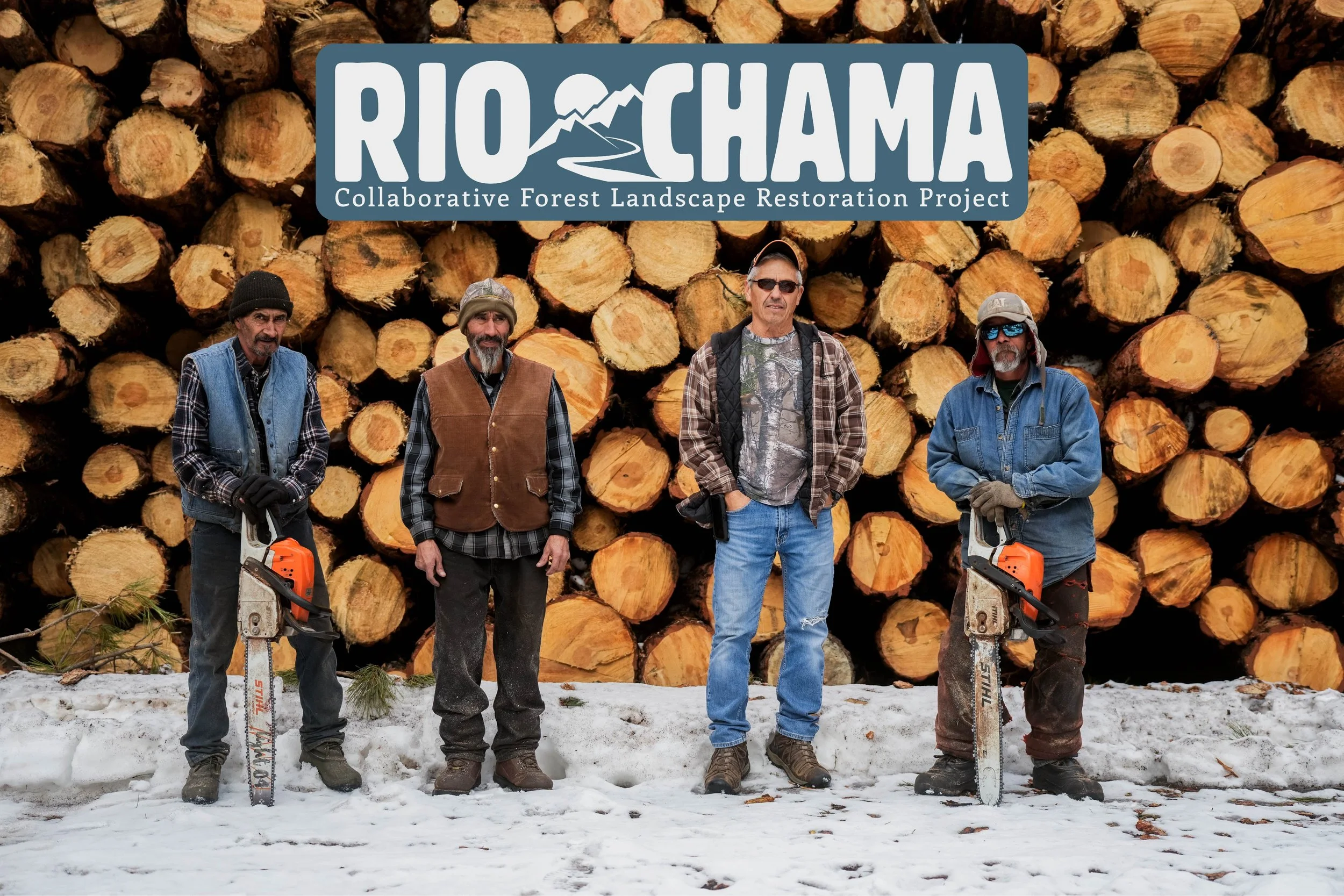 Four men standing outdoors in front of a large stack of cut logs with a logo that reads 'RIOCHAMA' and 'Collaborative Forest Landscape Restoration Project' overlaid at the top. The men are dressed in outdoor work clothing, with two holding chainsaws, and are standing on snow.
