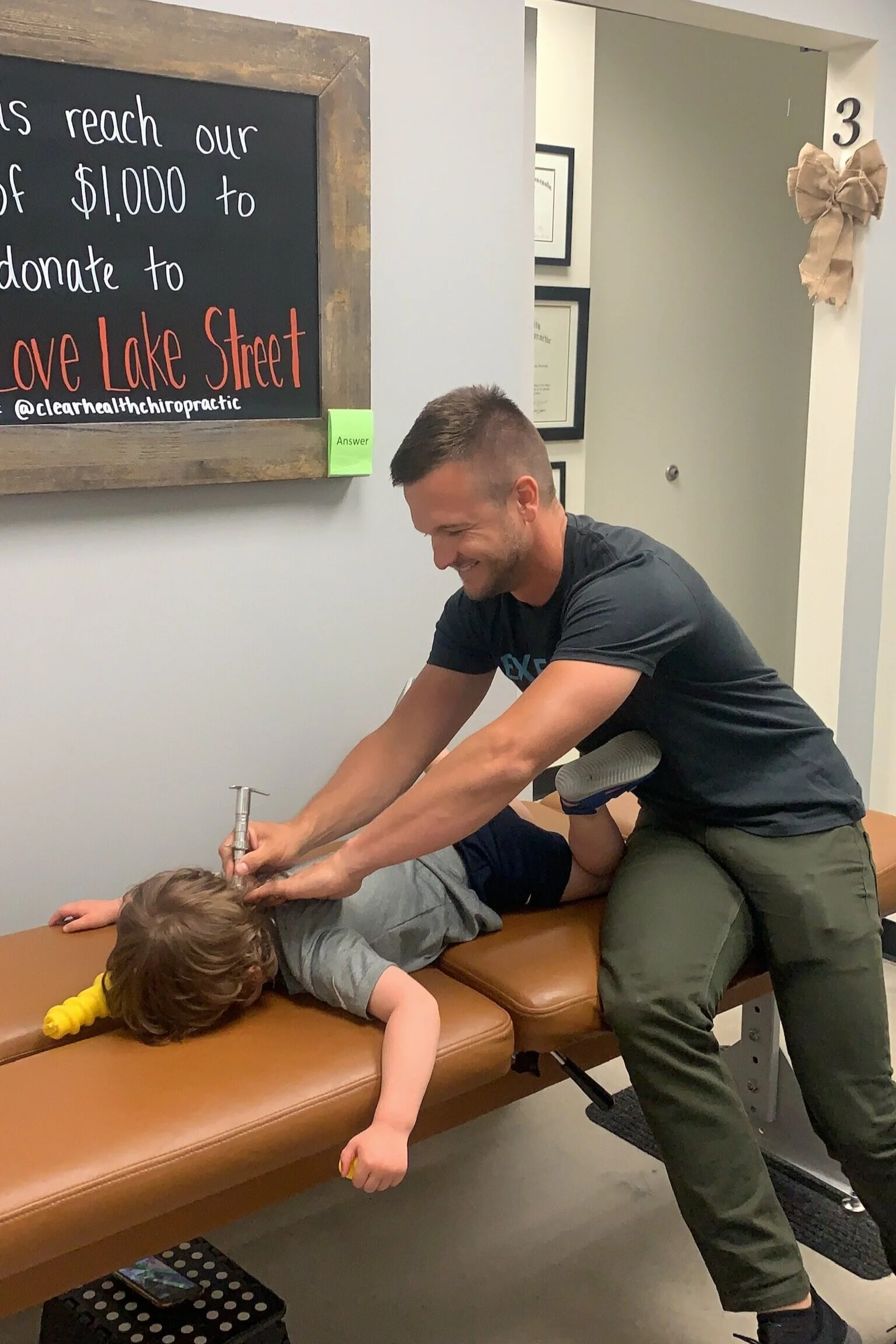 Photo of chiropractor adjusting a child.