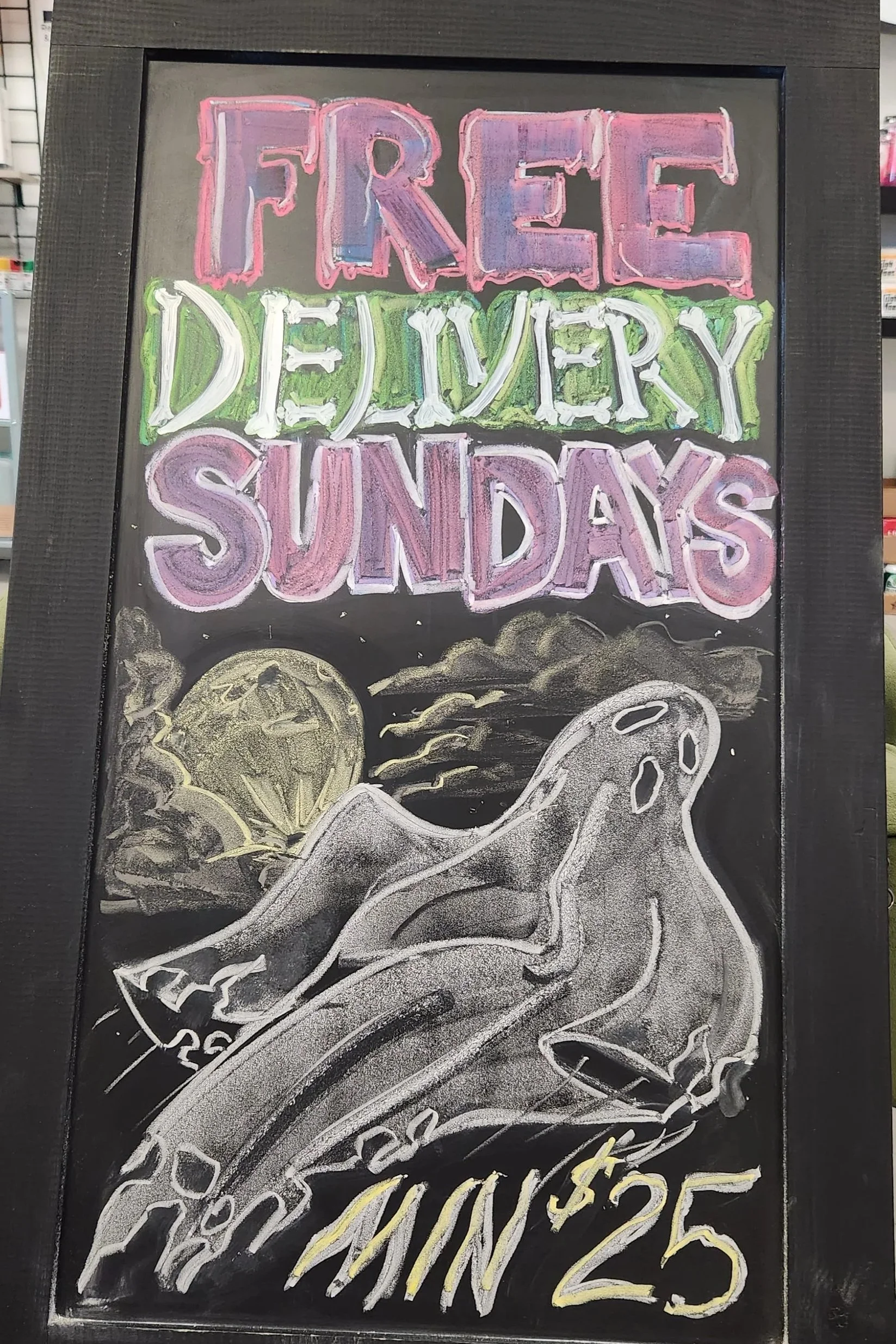 Colorful chalkboard sign with the message 'Free Delivery Sundays' at the top, followed by an illustration of a pizza slice with toppings and the text 'Pizza $$' at the bottom, advertising free pizza delivery on Sundays.