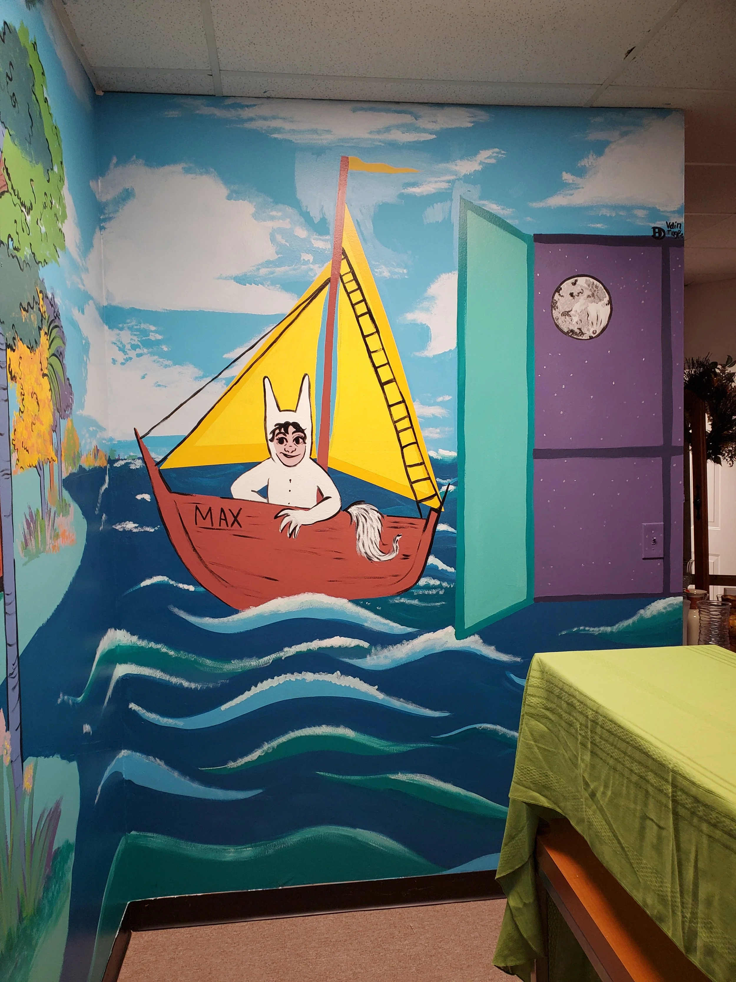 Colorful mural featuring a white cartoon character with black hair and a tail, sitting in a small boat labeled 'Max' on a body of water with waves. The boat has a yellow sail, a red hull, and a pink mast. The scene includes a bright blue sky with white clouds, a pink and teal triangular wave, and a purple starry night sky with a full moon in the background. To the left, part of a green landscape with trees and colorful foliage is visible.