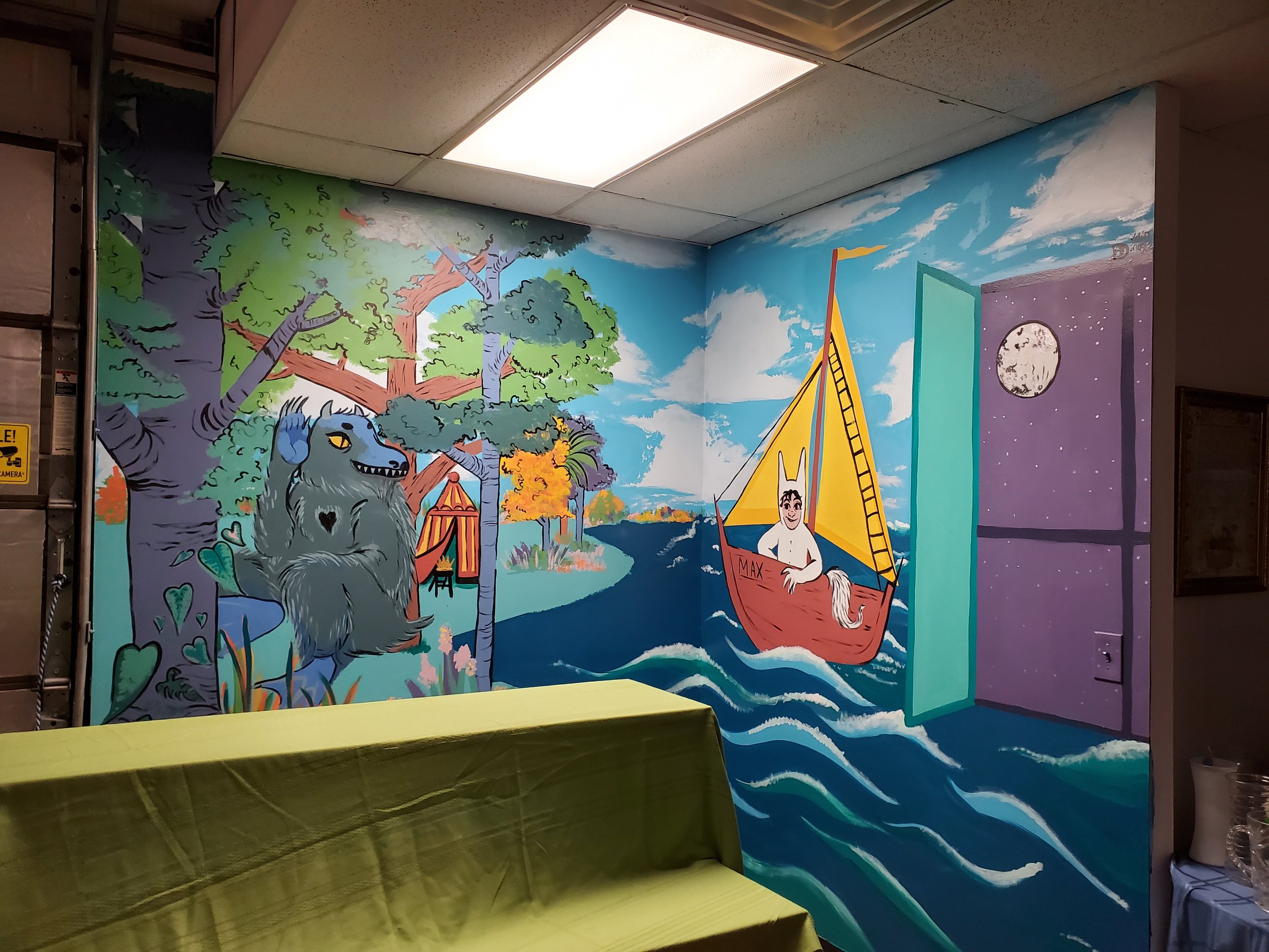 Colorful mural with trees, a blue wolf, a yellow tent, and a boat with a person on a blue water background.