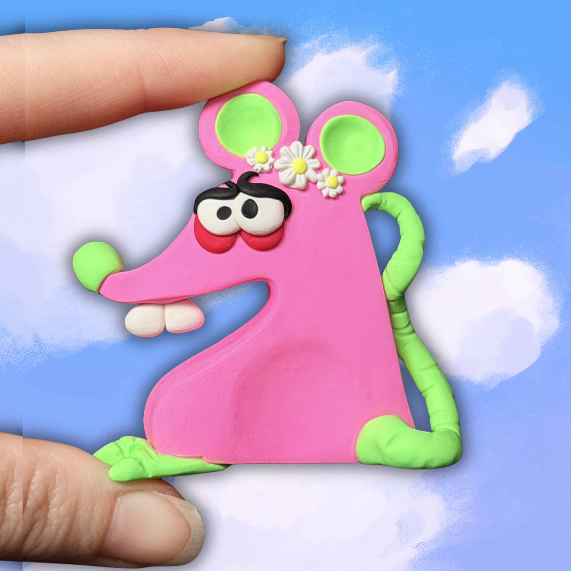 Quirky cute at shaped worry stone with big teeth and foot that stands up. Pink body with a white flower crown.