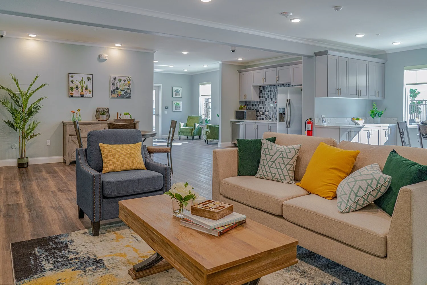 Lounge Area in Turtle Creek resident clubhouse with couch seating, a dining table and kitchen. 