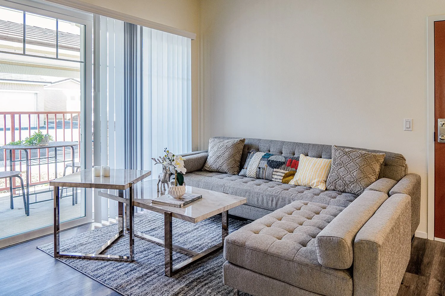 Living Area in Turtle Creek Apartment Home with wood-style plank flooring and large sliding doors leading to private patio.