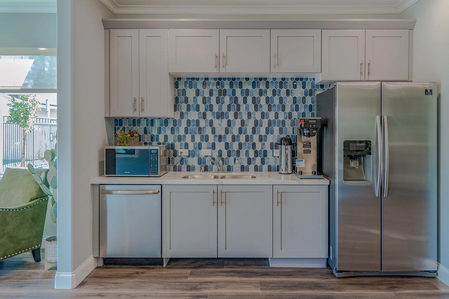 Community kitchen in Turtle Creek resident clubhouse with a refrigerator, dishwasher, and plenty of counter space and cabinetry.