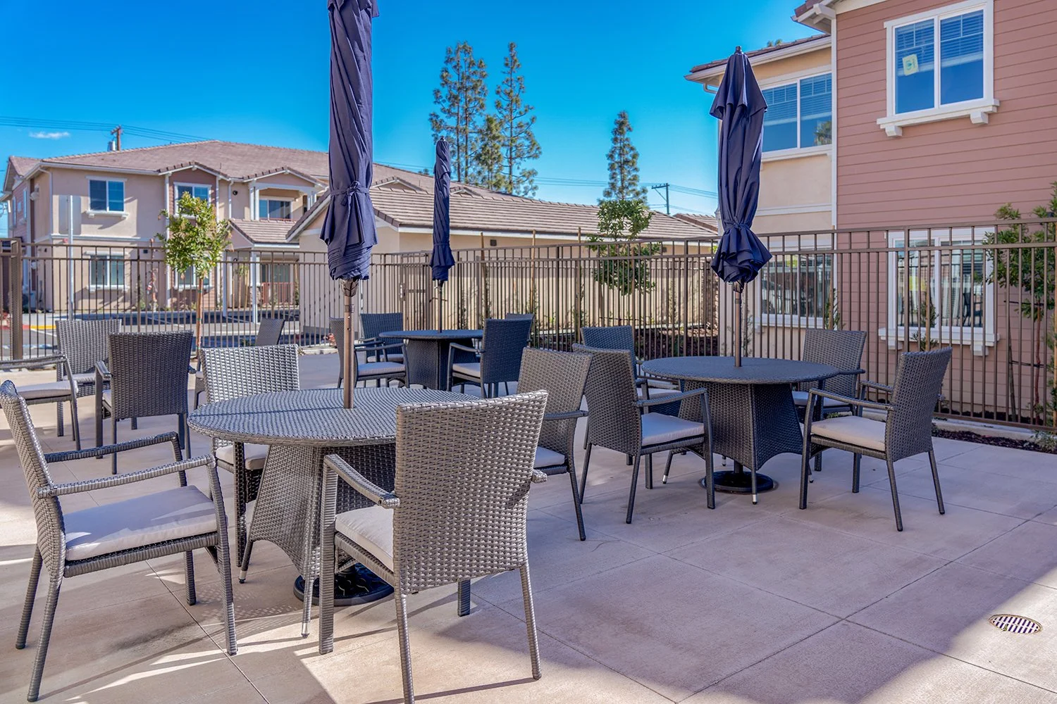 Picnic Area at Turtle Creek with multiple sets of four-top tables and umbrellas for shade