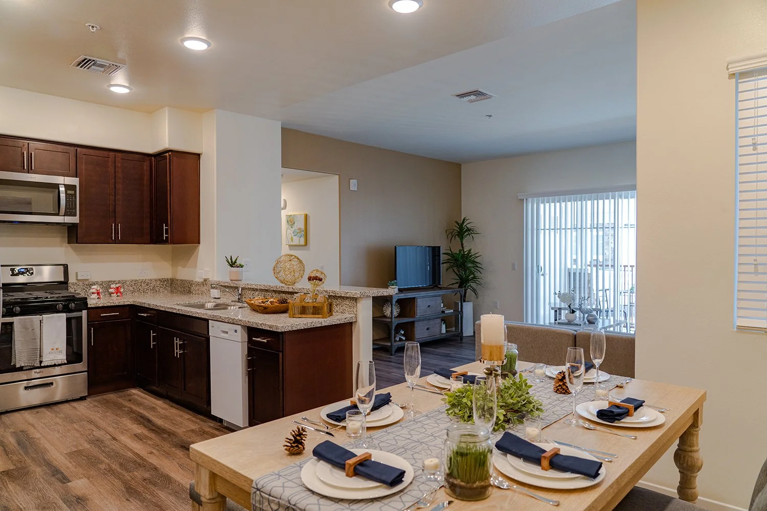 Dining Nook in Turtle Creek apartment home with wood-style plank flooring and charming window. Open concept layout allows for a spacious feel and an easy flow throughout the apartment space. Dining nook is off to the right of the kitchen and overlook