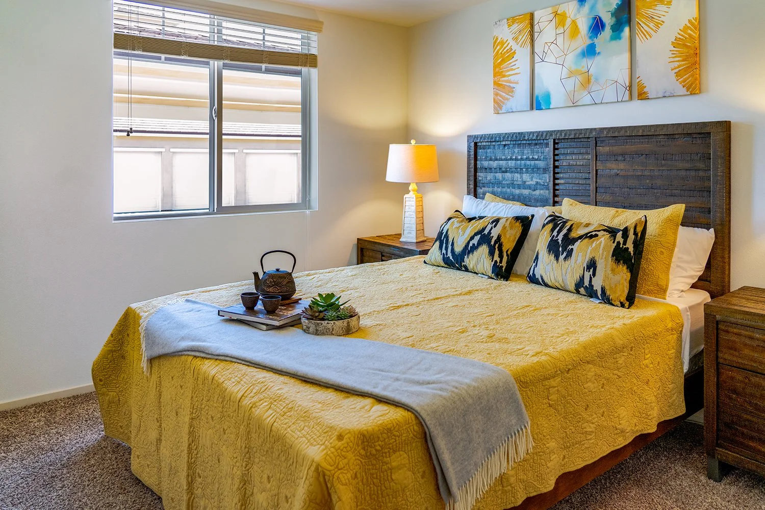 Bedroom in Turtle Creek apartment home with carpeted flooring and large window allowing for gorgeous natural lighting in the bedroom. 