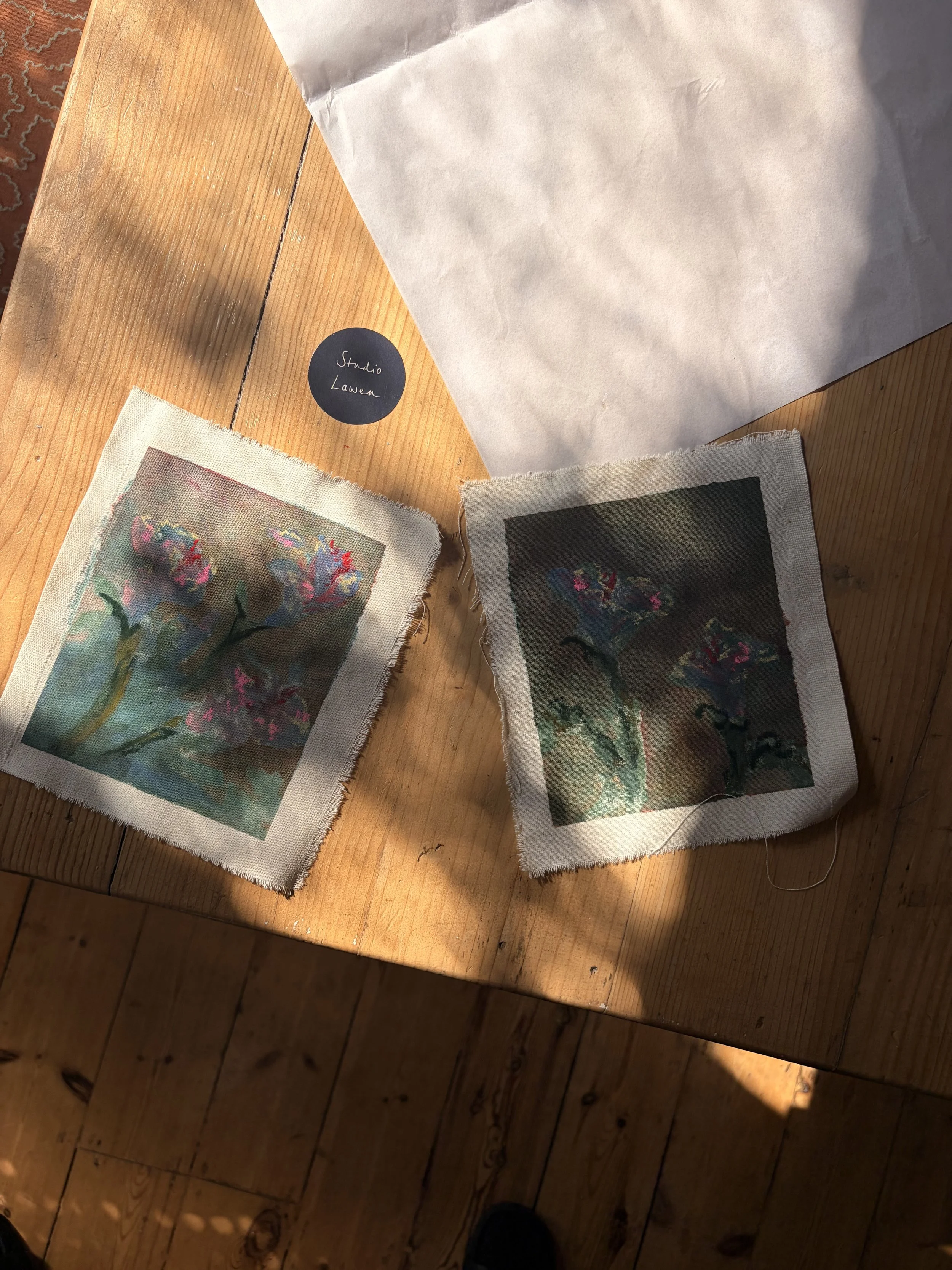 An overhead photo of two contemporary abstract floral paintings on canvas by studio lawen