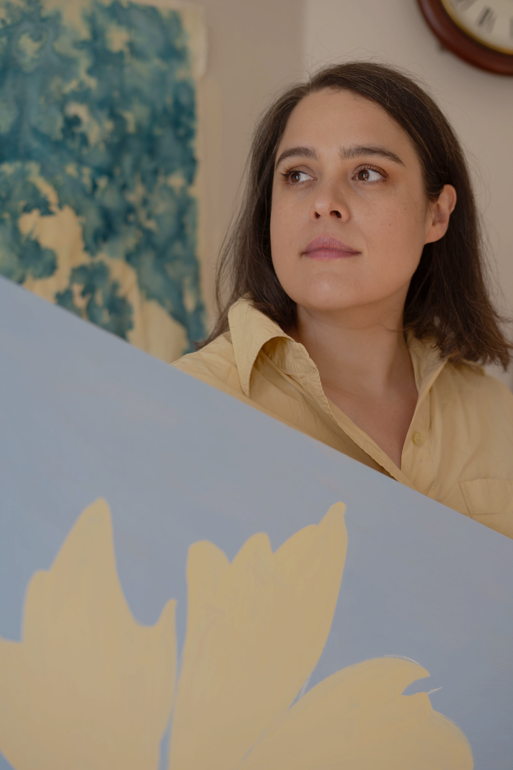 A photograph of Emily Burt from Studio Lawen with her large scale floral paintings