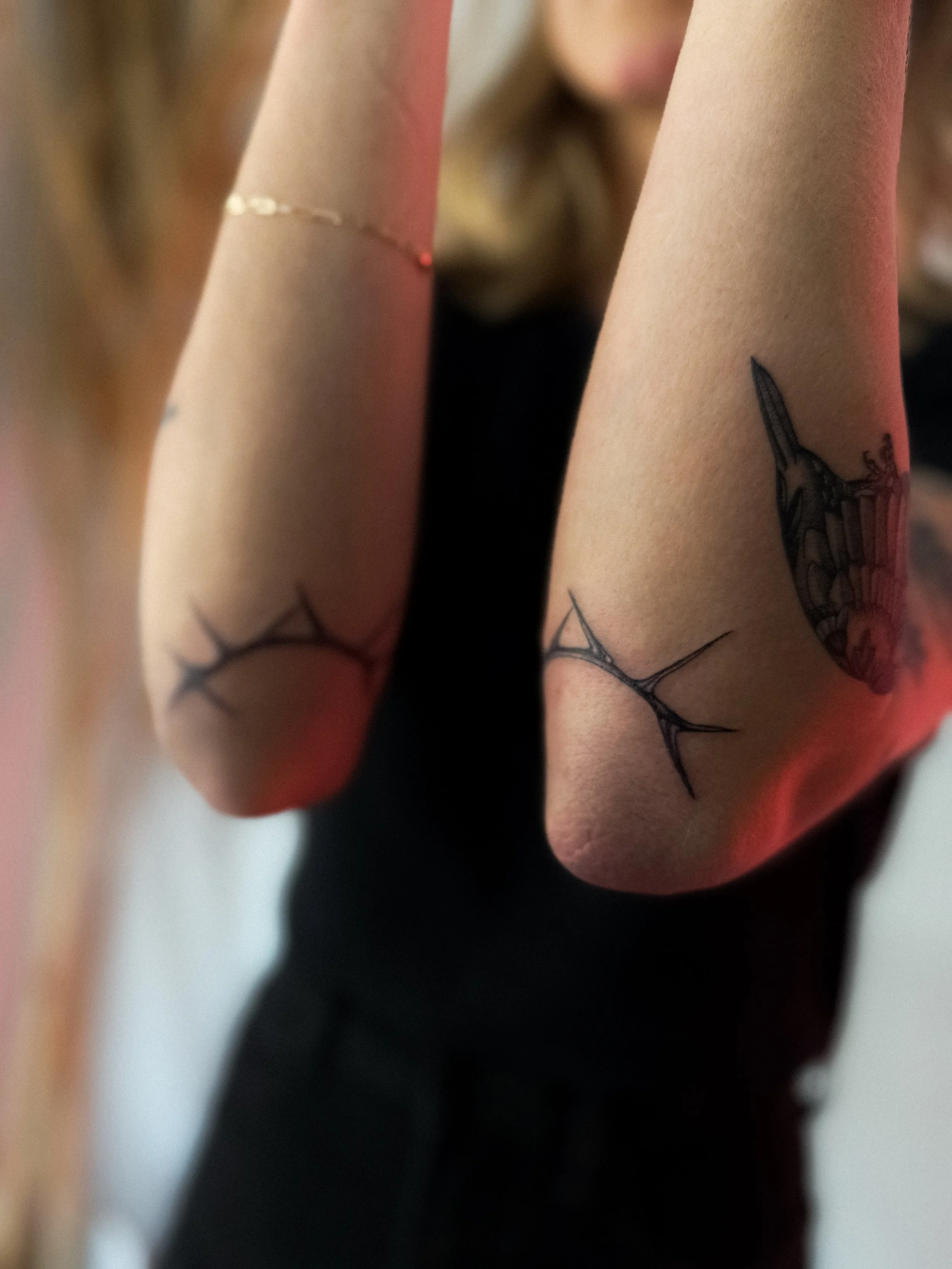 Southwest blackwork mesquite thorn mirrored flash tattoos on elbows