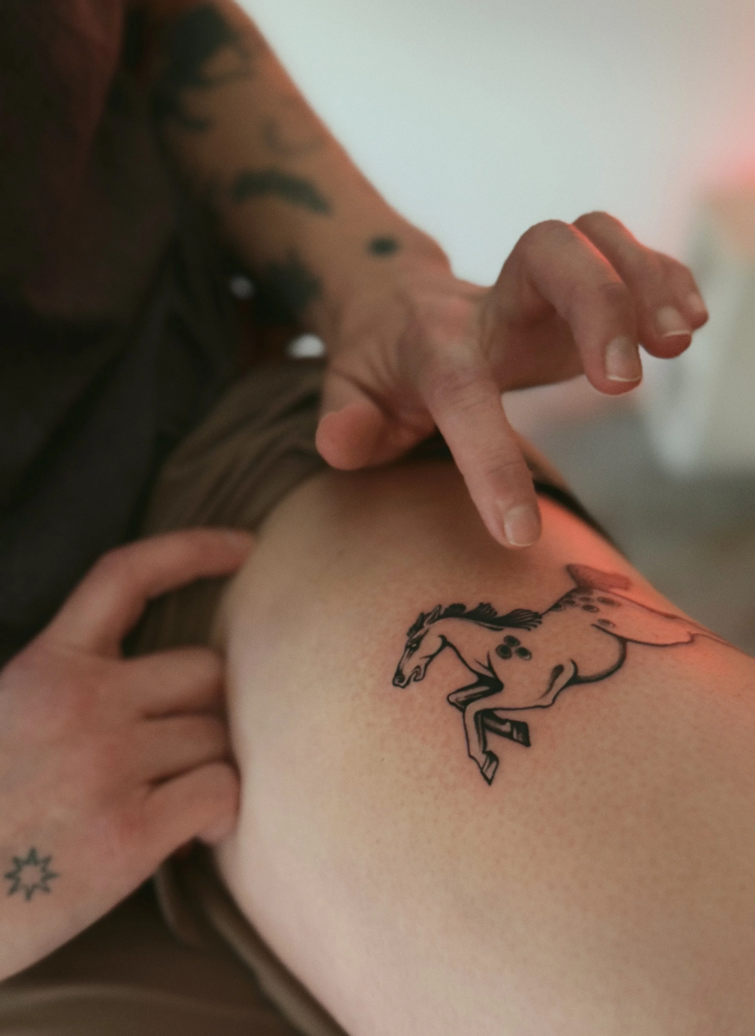 blackwork flash tattoo of horse on thigh
