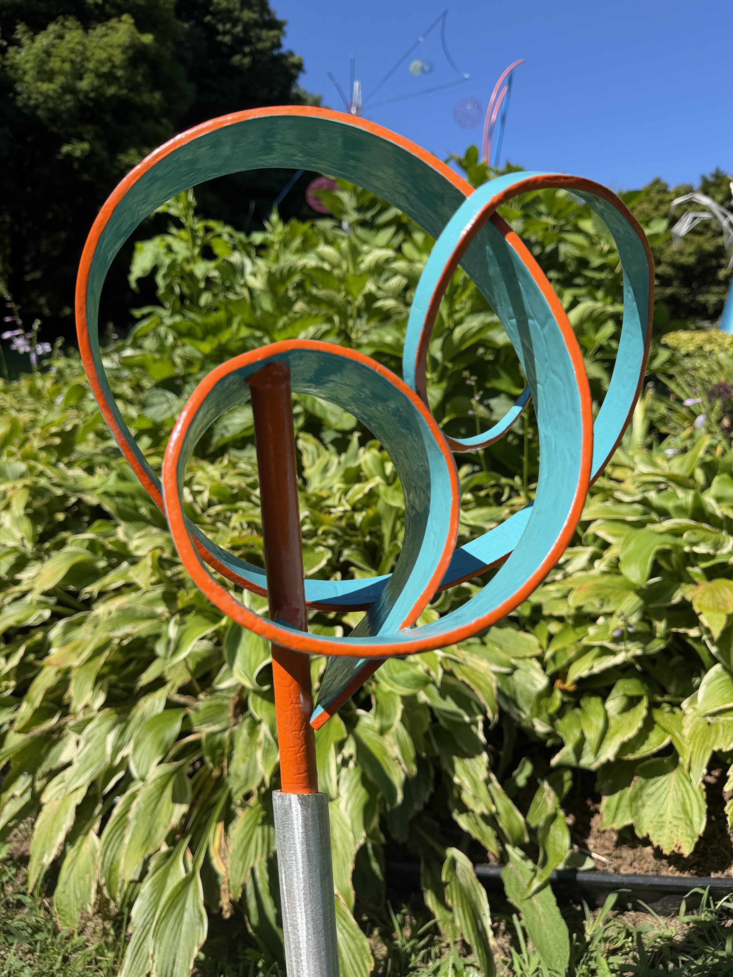 Aqua and Orange Energy Spiral | Hand-Curved Aluminum Sculpture by Jodi Carlson