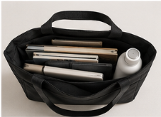 Bolsa negra con varios libros y un bote blanco
