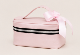 Estuche de color rosa con lazos rosados y cierre con cremallera negra y blanca