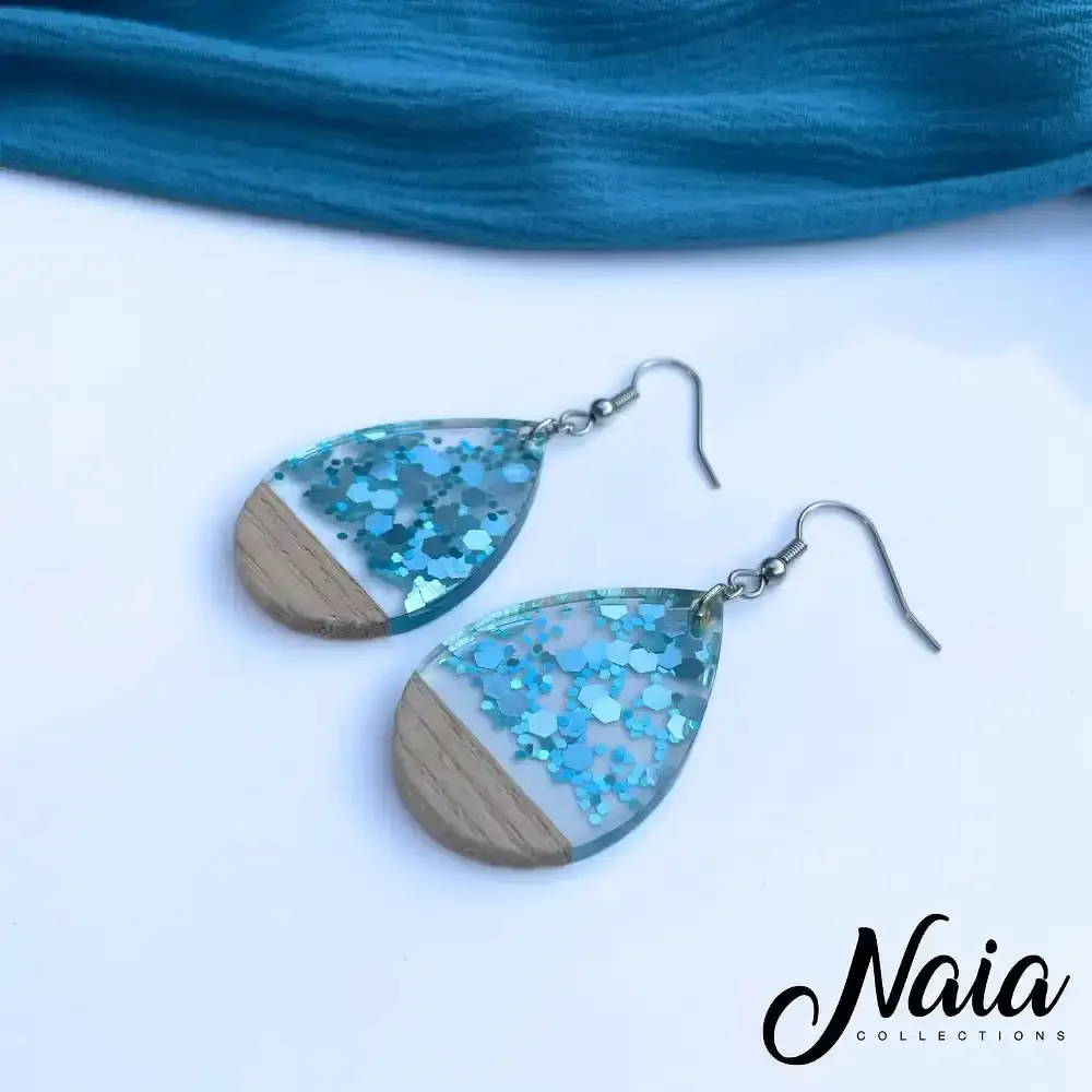 Light-blue-sparkly-wood-and-resin-dangle-earrings-1.webp