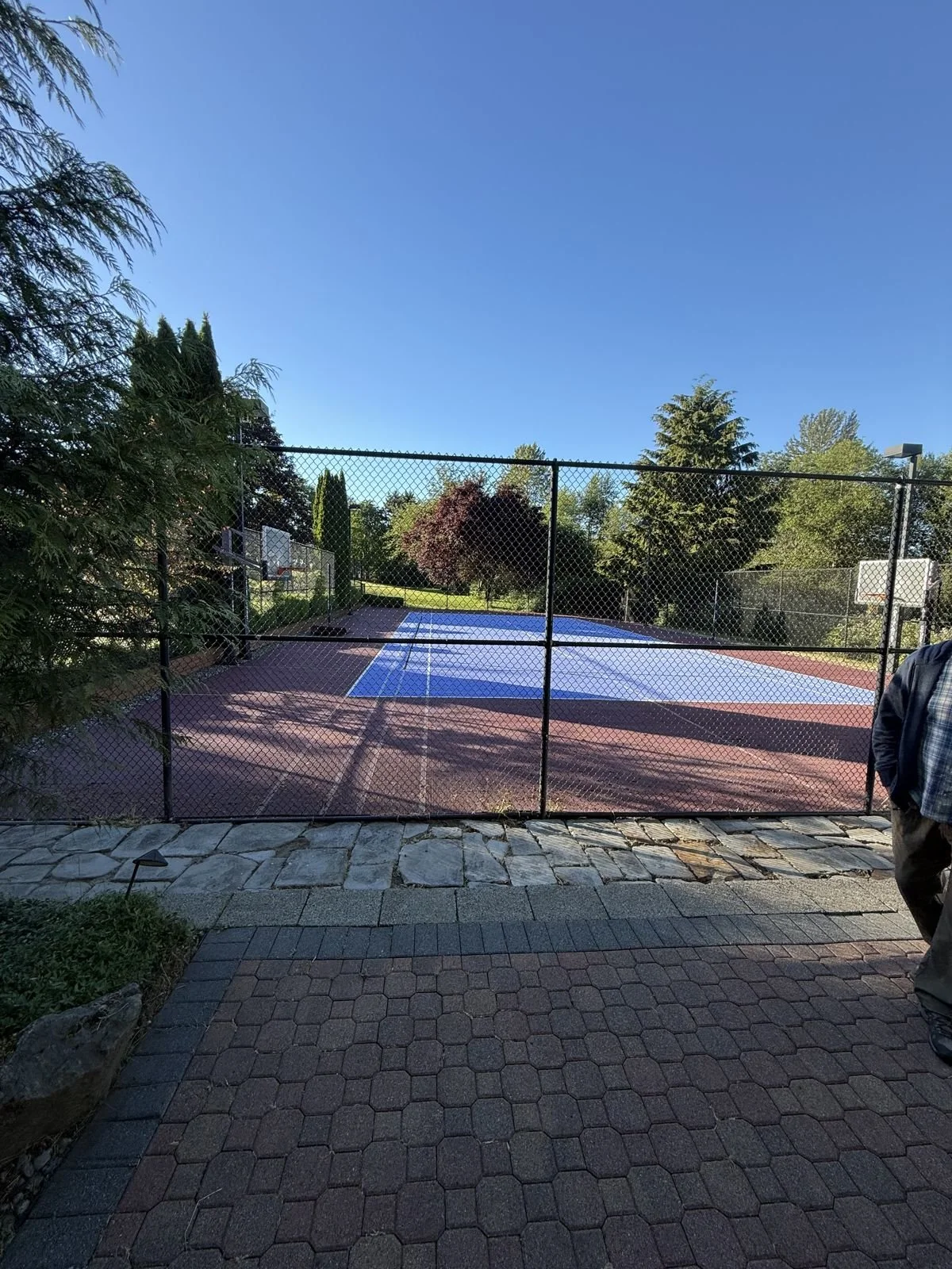 Fenced blue and red sport court before demolition in Snohomish WA