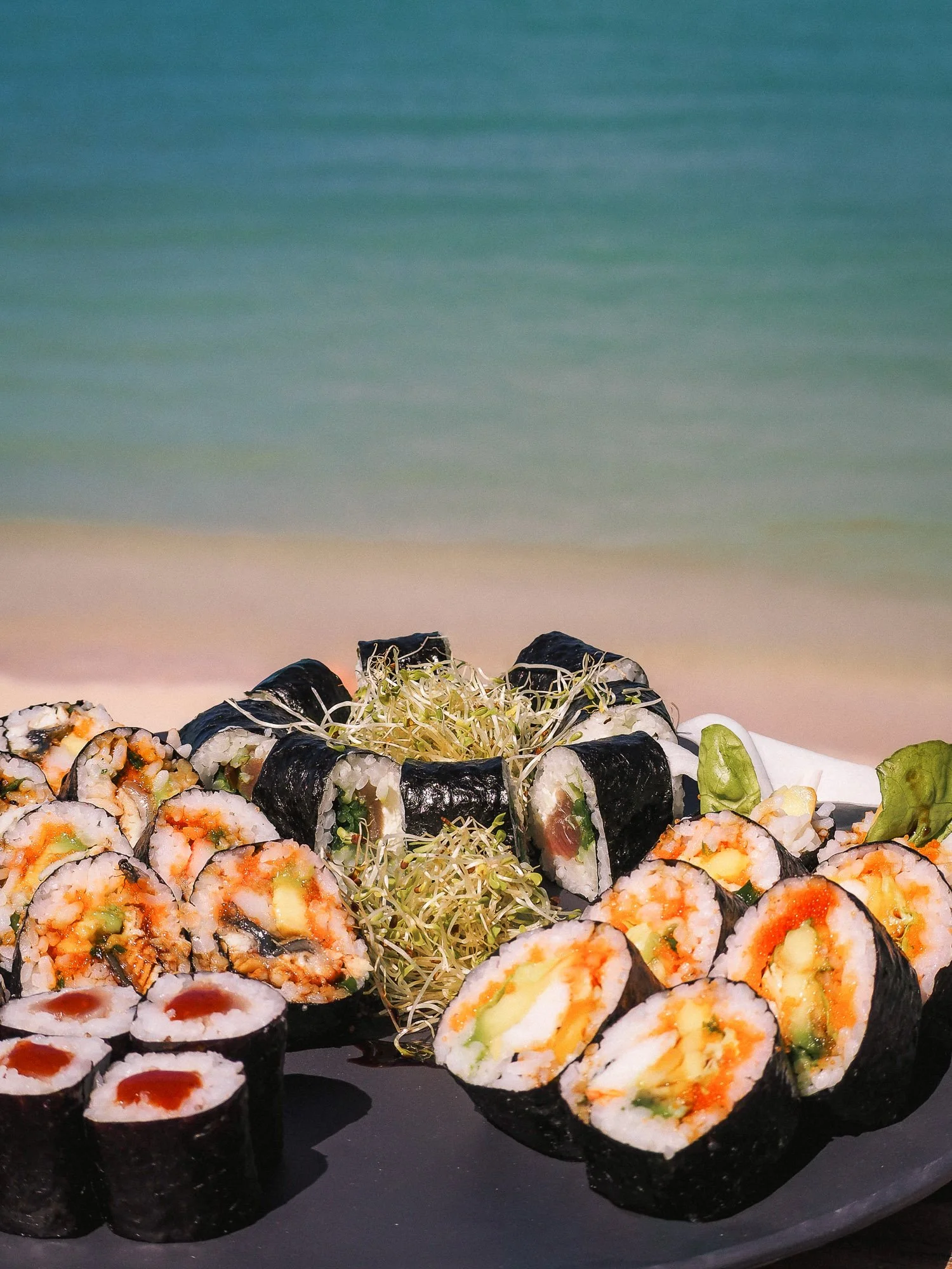 Fresh sushi roll platter with rice, seaweed, and fish, prepared by Croq'Sushi by Yo for beachside delivery in St Barth