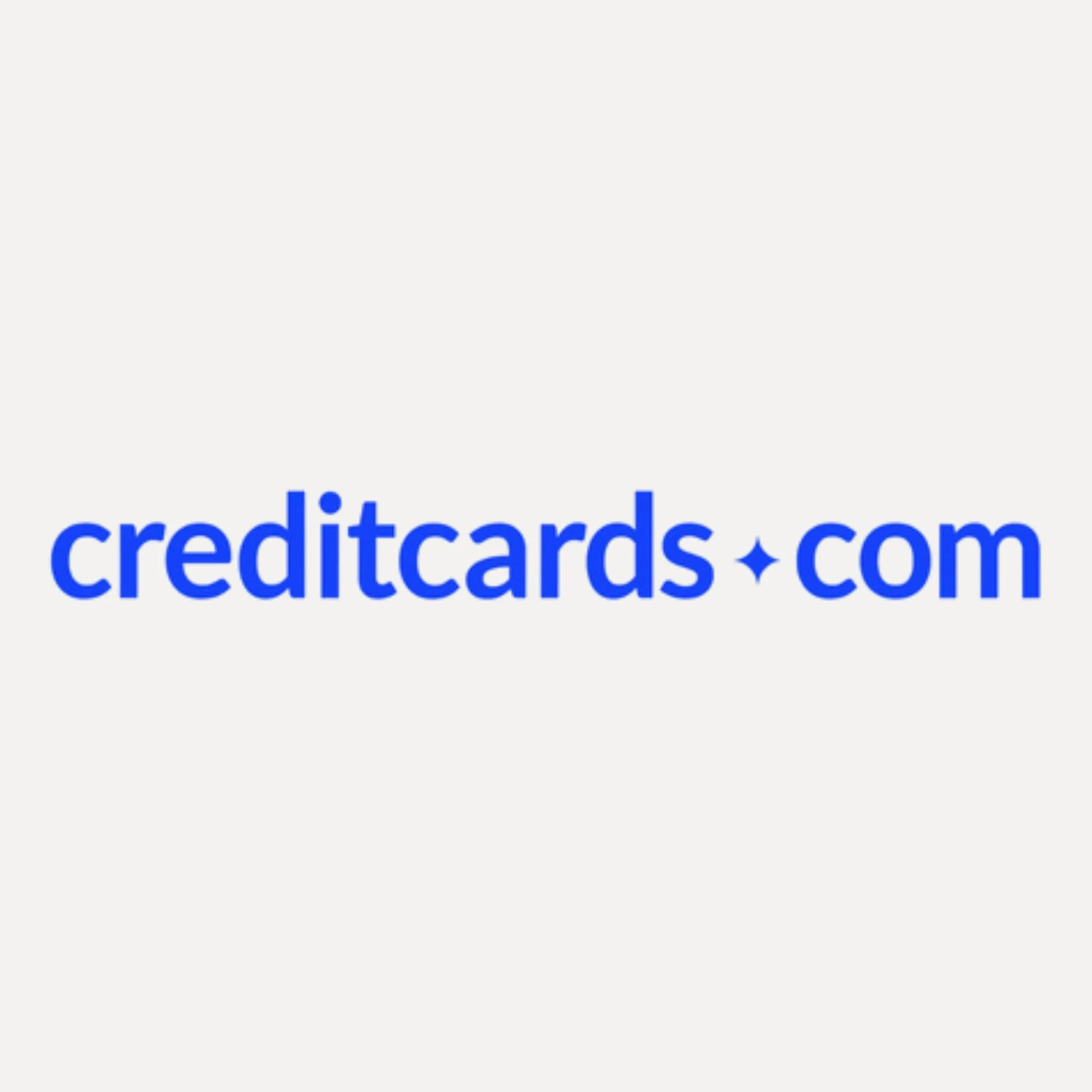 Partial view of a website header displaying the URL 'creditcards.com' in large blue font on a white background.