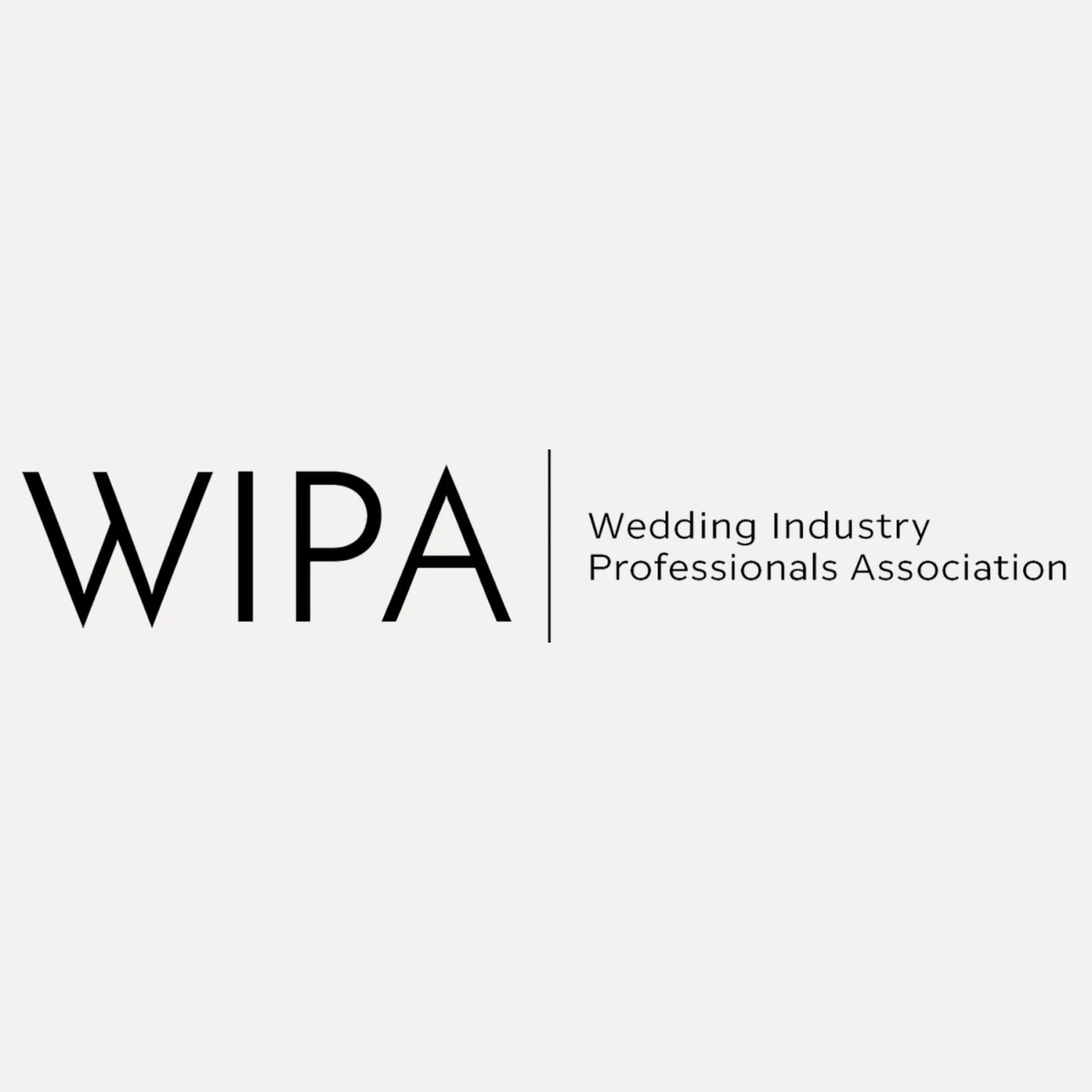 Close-up of a black and white sign with the text 'WIWPA Wedding Industry Professionals Association'.