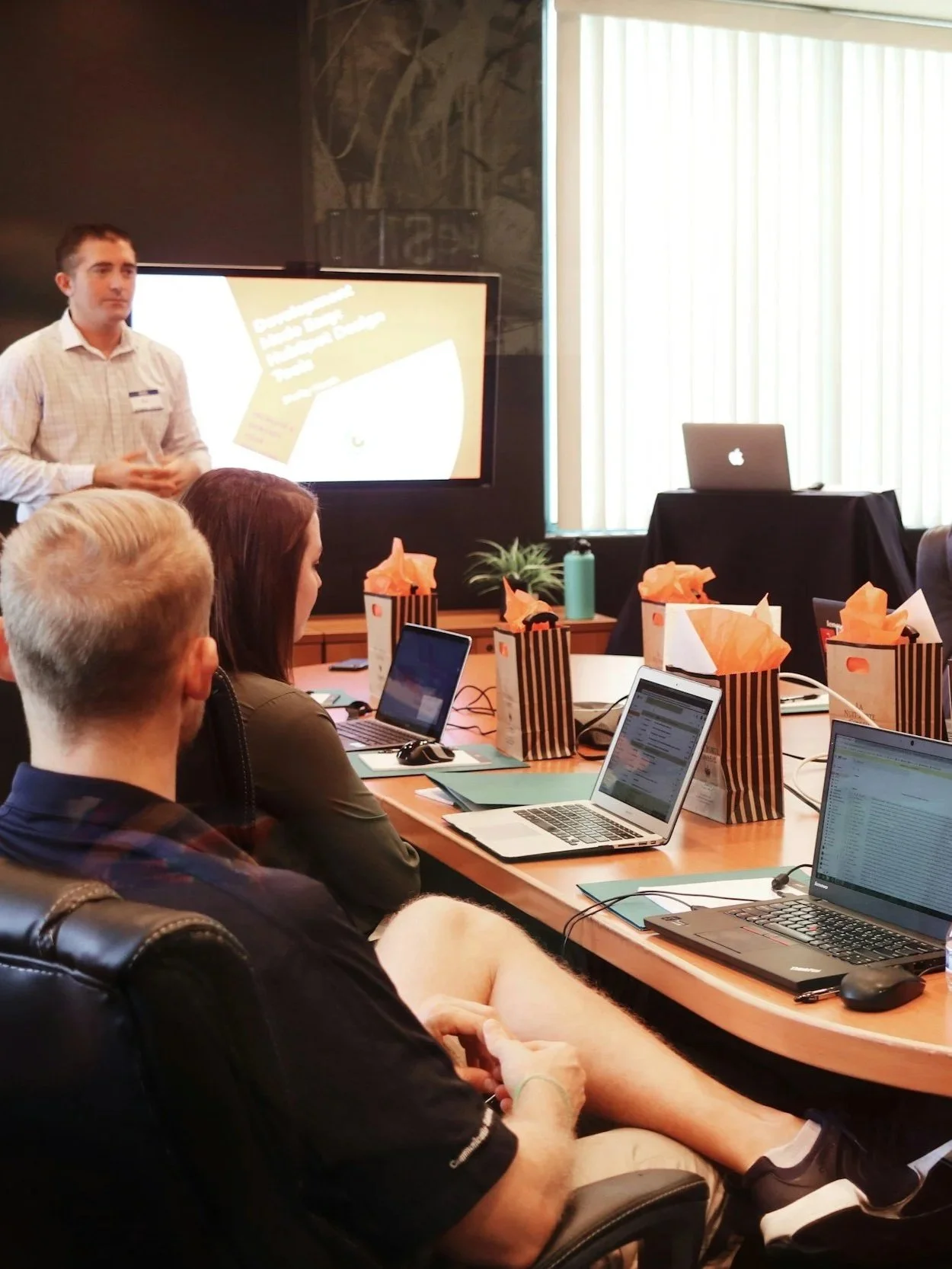 Speaker leading a training session in a conference room.