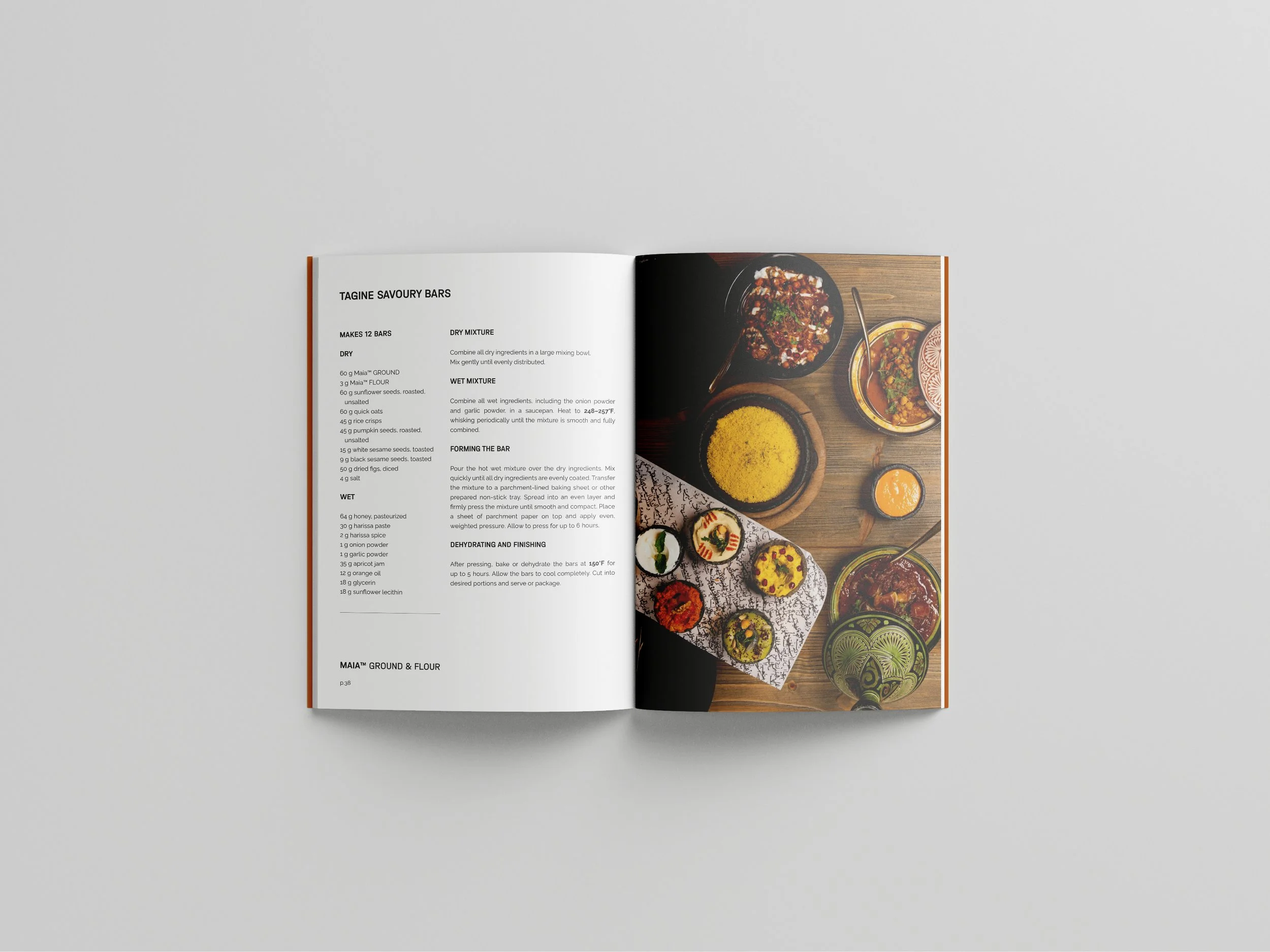 An open cookbook showing a recipe for savory bars on the left page and a photo of various Indian dishes on the right page.