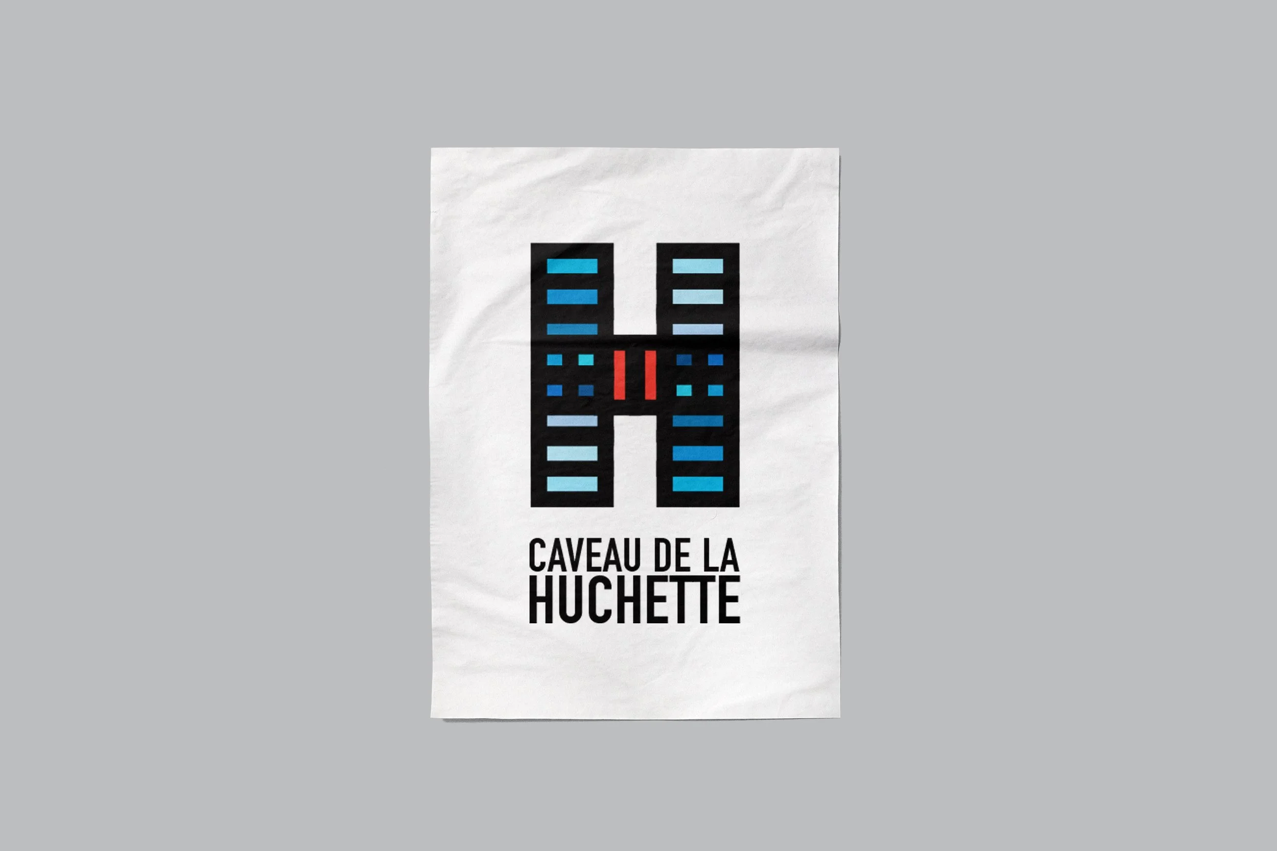 A poster with a large print of a logo in black and blue, and the text "CAVEAU DE LA HUCHETTE" below it.