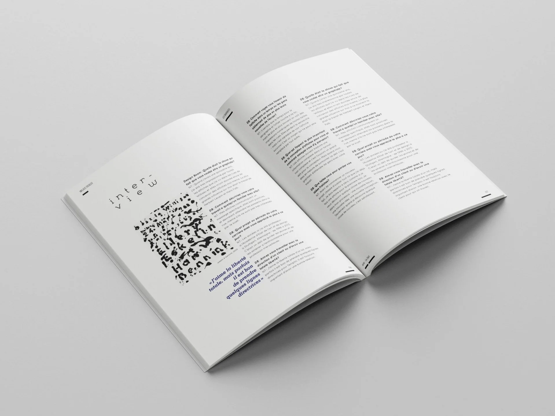 An open book on a gray surface with white paper and black text, featuring a black fingerprint graphic on the left page.