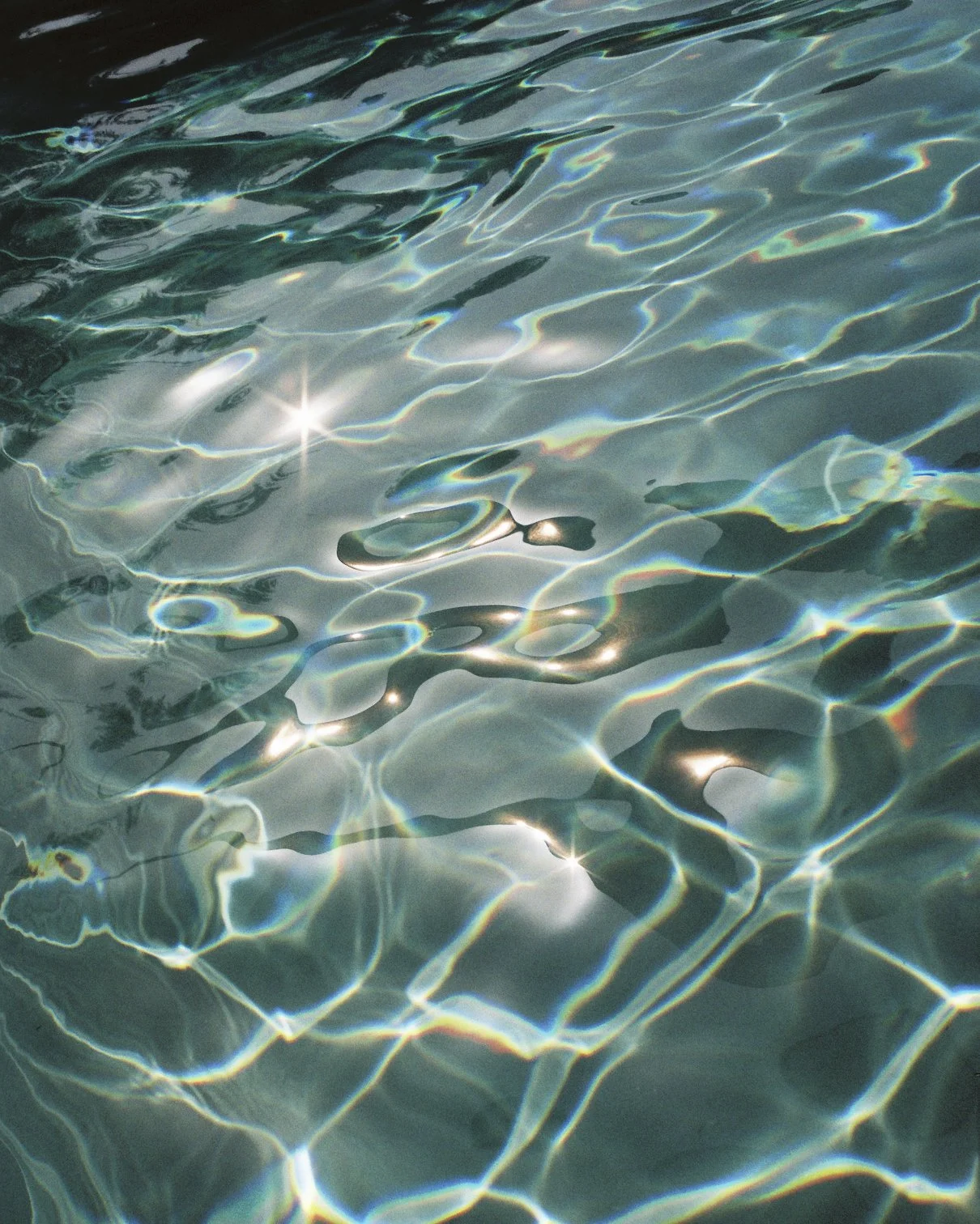 Reflection of sun on swimming pool water