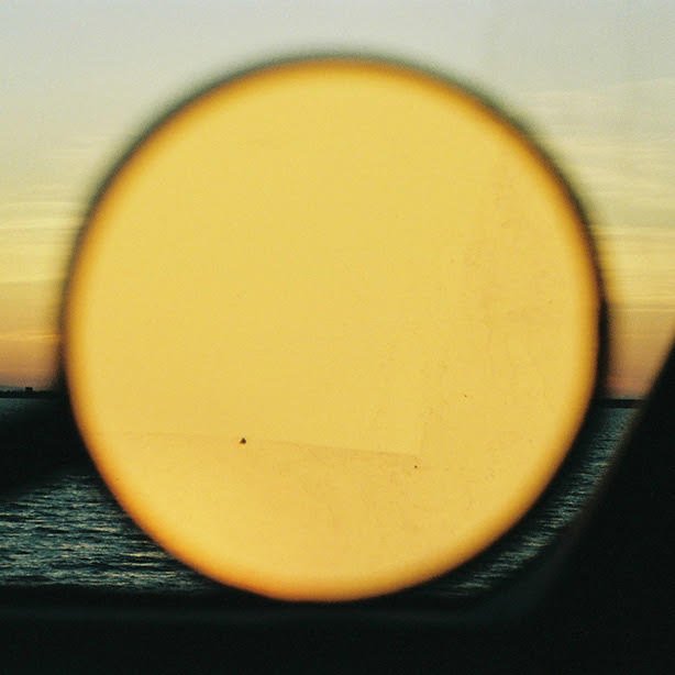 Magnifier pointing at the sunset 