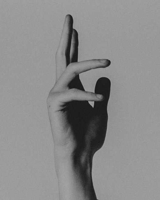 Close up of a man's hand pointing to the sky