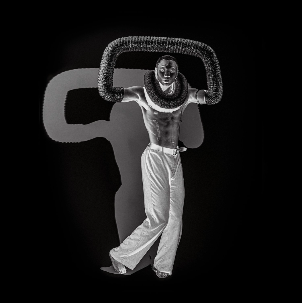 Inversed black and white image of a man in studio