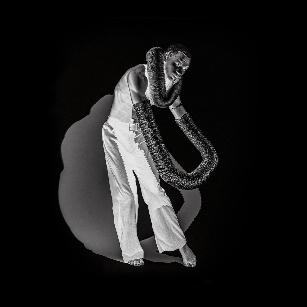 Inversed black and white image of a man dancing