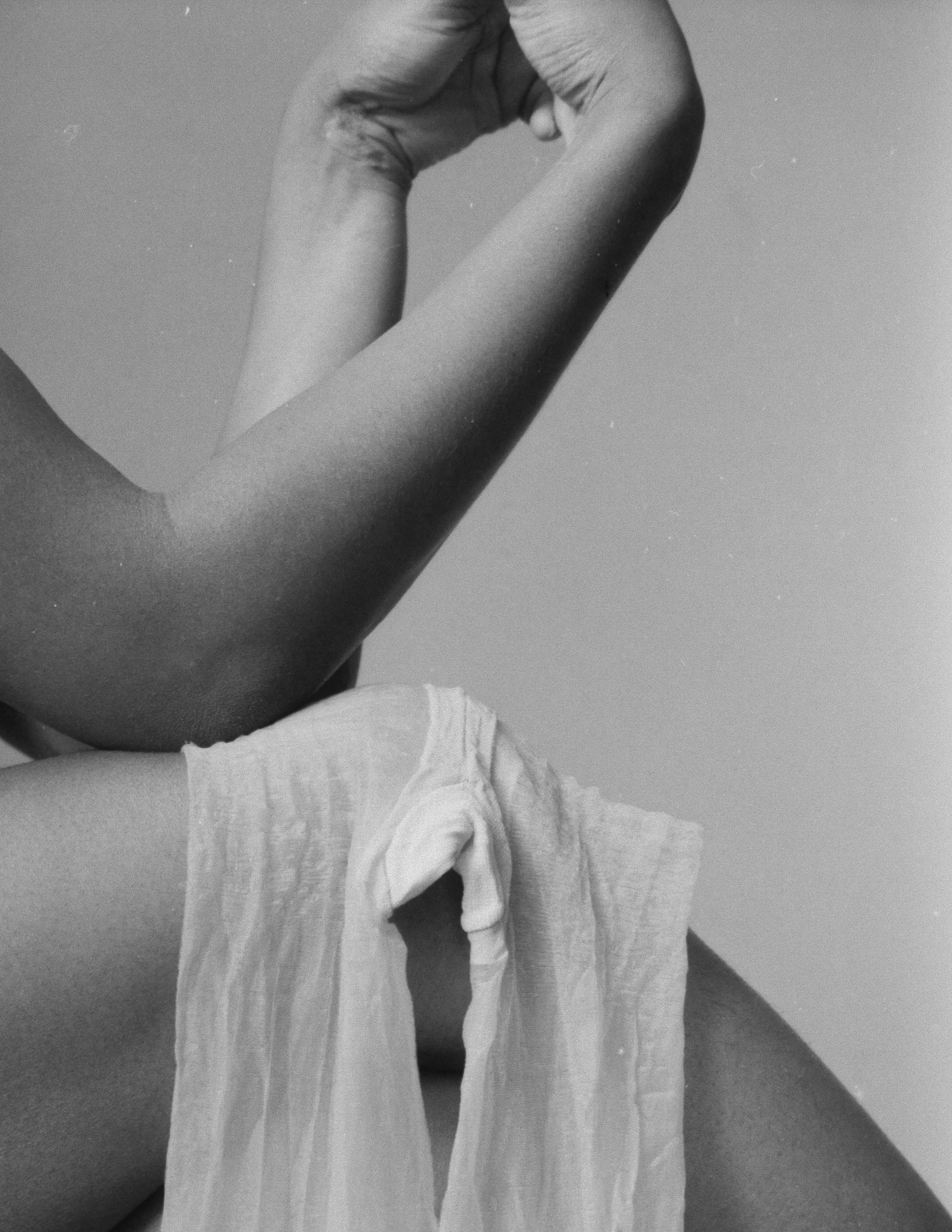 Woman with her legs and crossed, resting on her knees