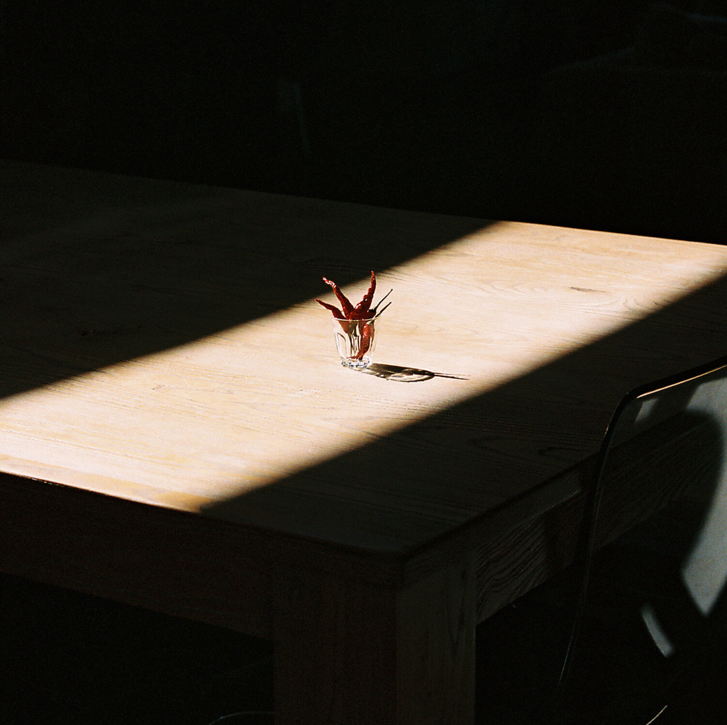 Still life of red peppers on a wooden table
