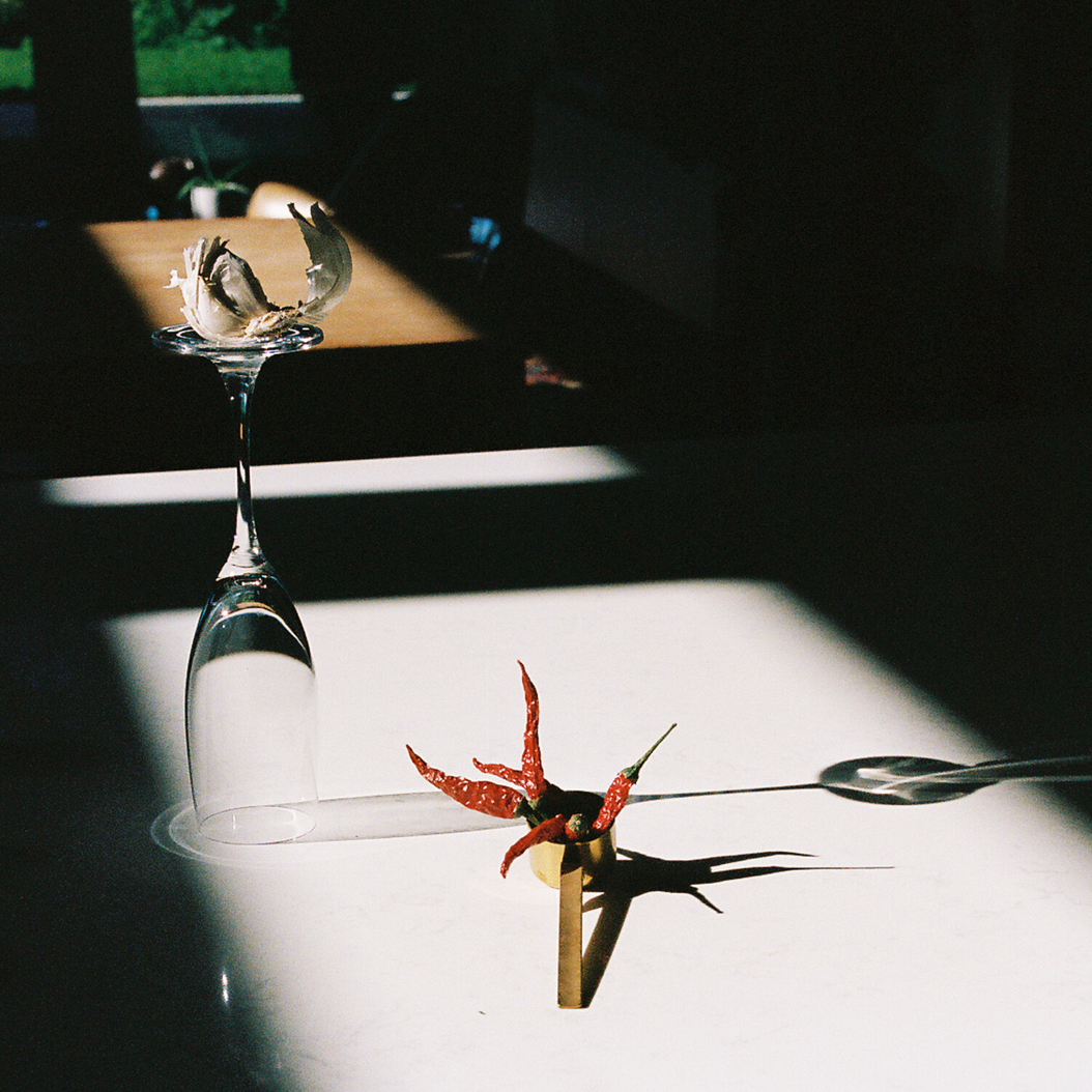 Still life arrangement on a table with red peppers