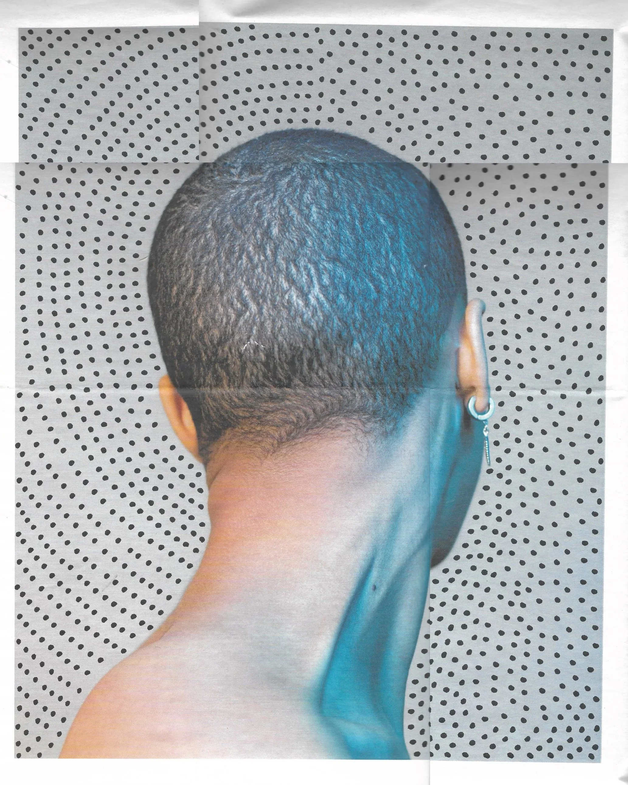 Close-up of the back of a person's head with short curly hair, wearing an earring, against a polka dot background.
