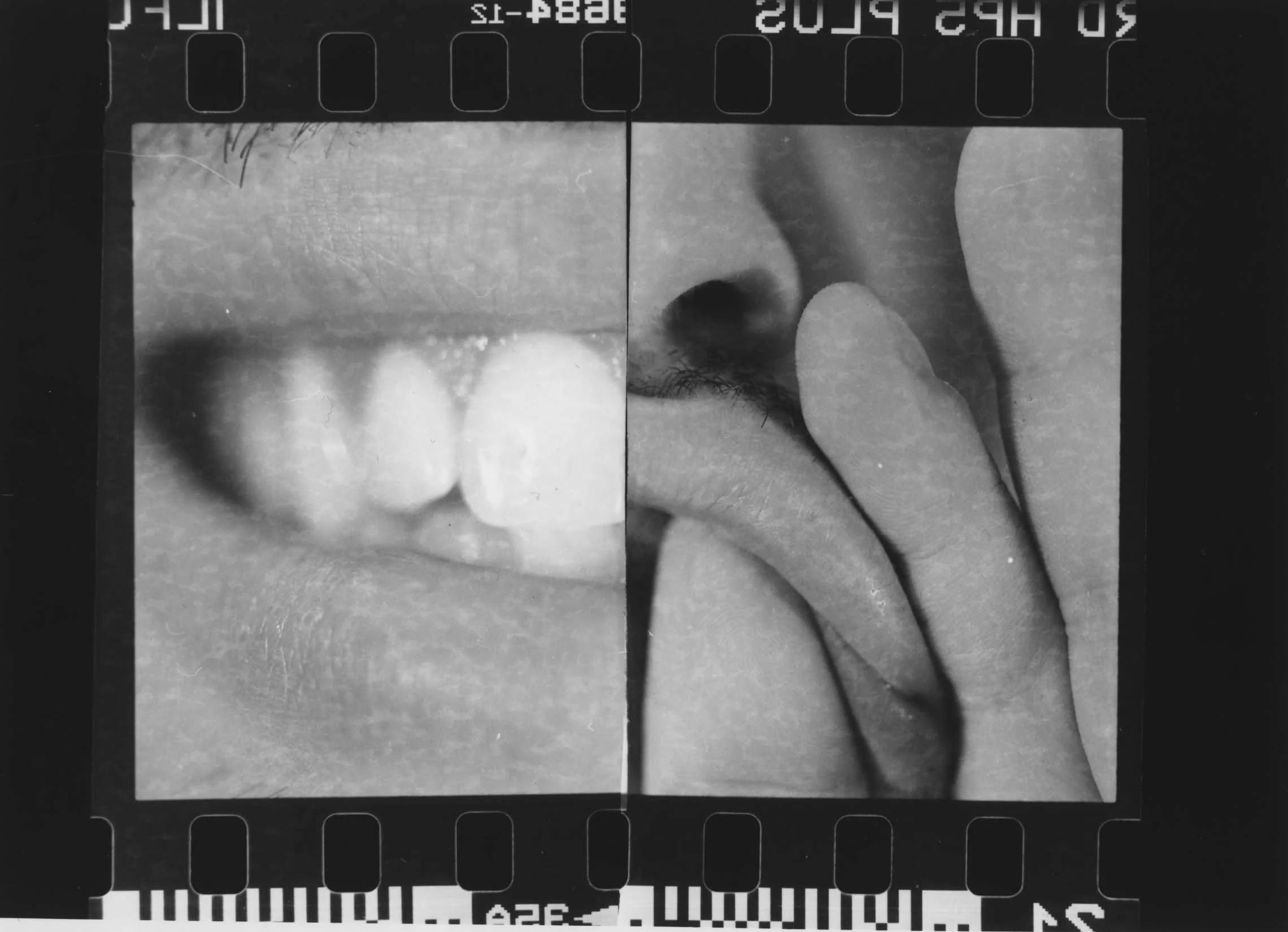 Close-up of a section of film with images of a person's eye and a finger touching the eye, printed text partially visible at the top and bottom.