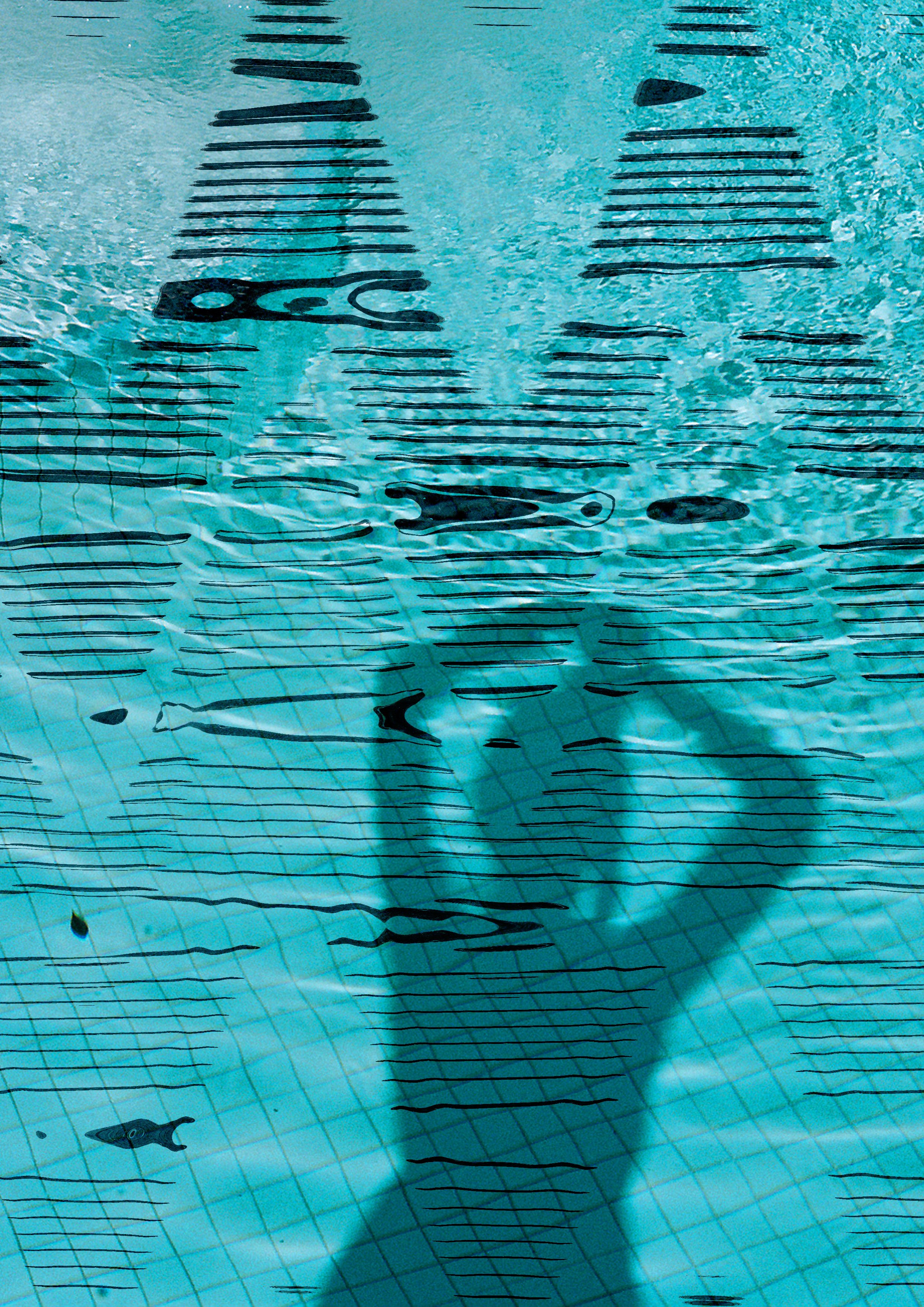 A swimming pool with lane lines and a swimmer underwater, viewed from above.