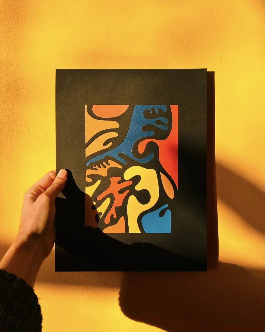 Colourful bright image of a paper collage with multiple colours and squiggles 