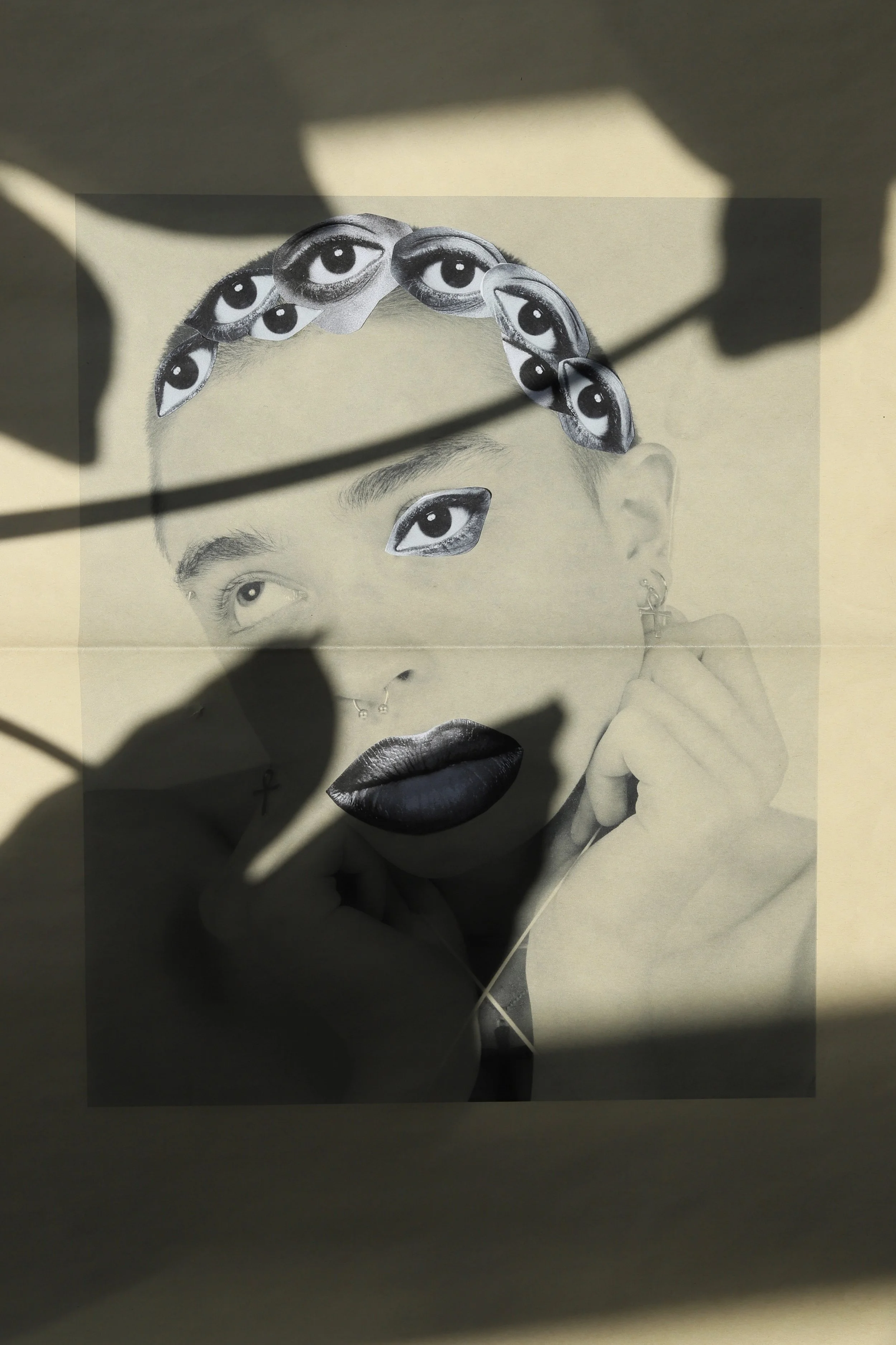 Artistic collage featuring multiple eyes, lips, and a hand holding a hairpin, with shadows cast across a beige background.