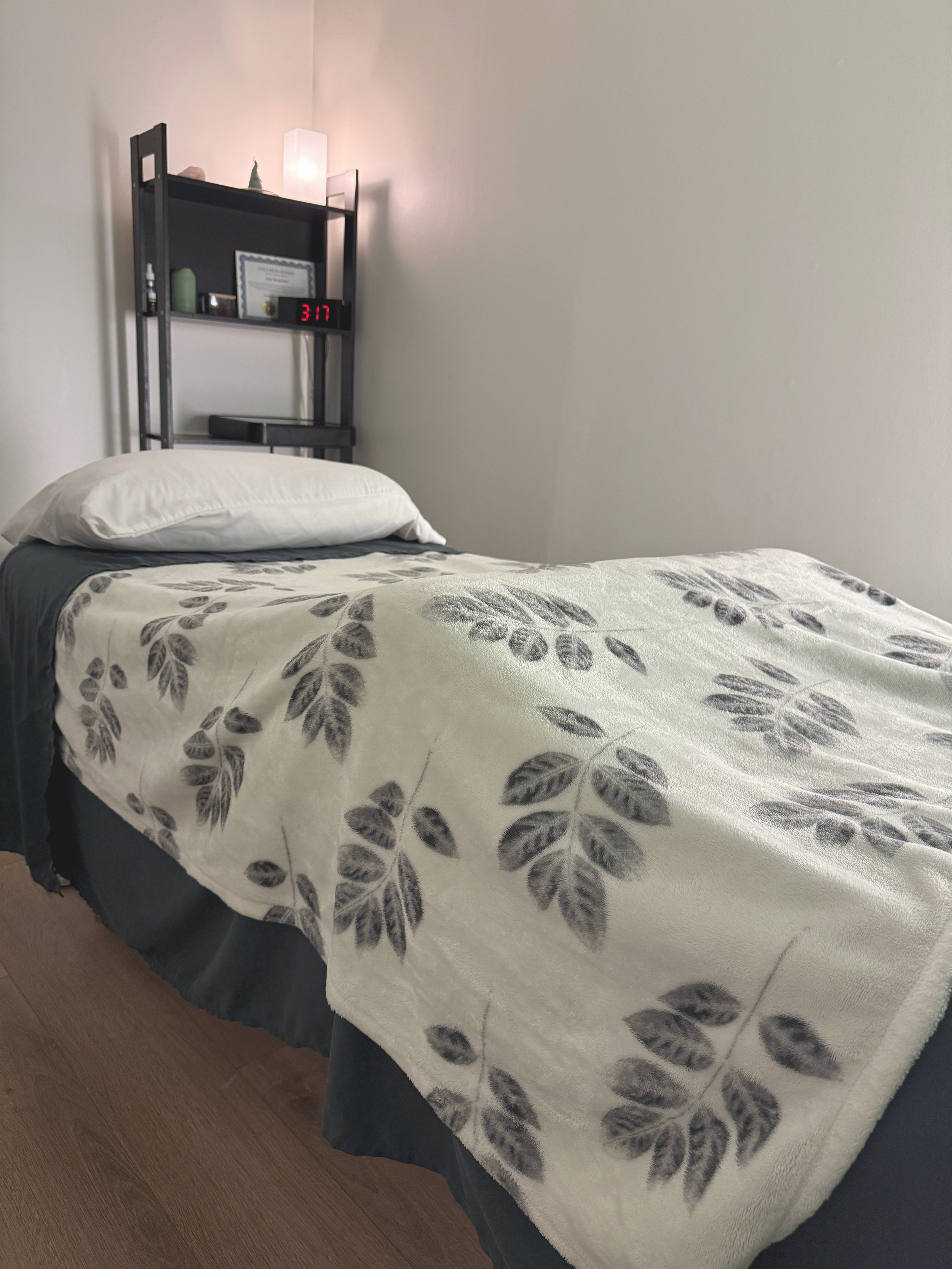 Reiki treatment table at Wild Heart Reiki, prepared with pillows and a botanical blanket.