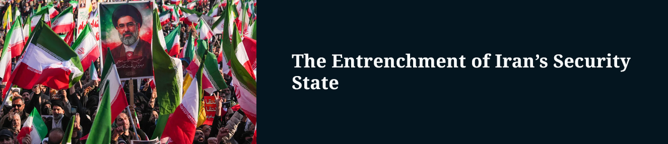 A large crowd holding Iranian flags and a portrait of a man with a beard and glasses, in front of a dark blue background with the text "The Entrenchment of Iran's Security State."