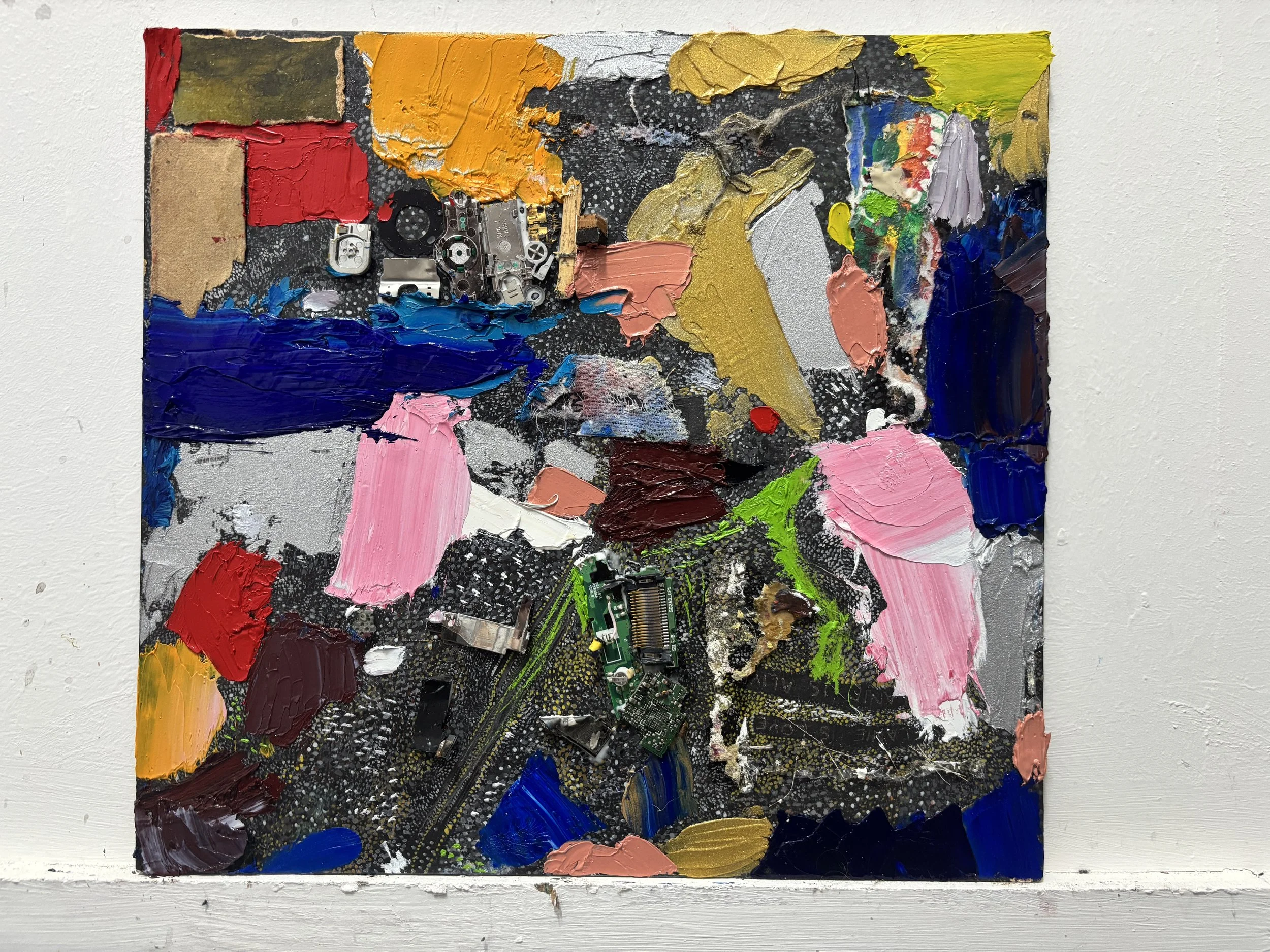 Abstract mixed media art on canvas with thick paint strokes and electronic circuit components incorporated into the artwork.