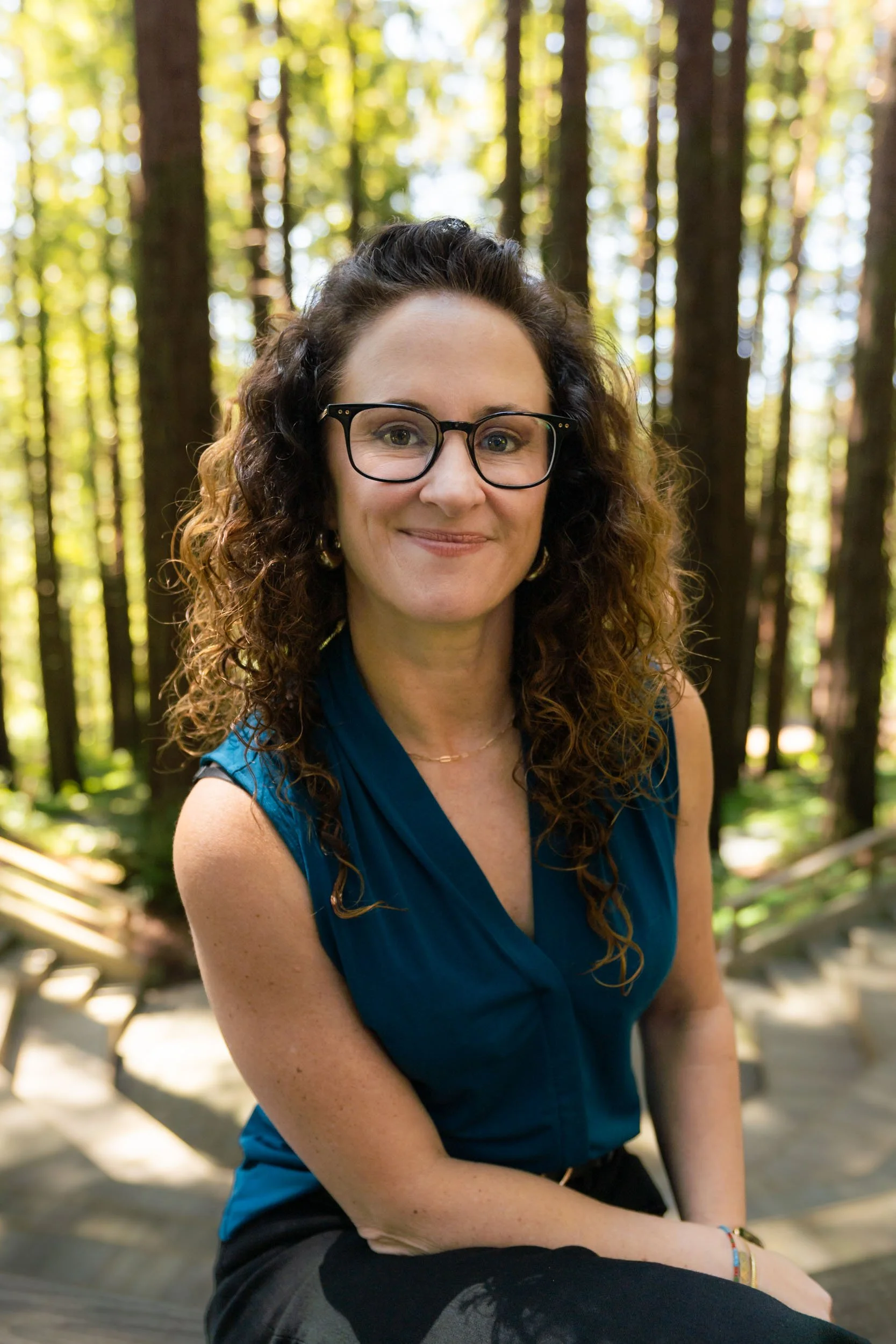 Ellie Vargas, LCSW, Certified IFS Therapist and Consultant smiling in a redwood forest.