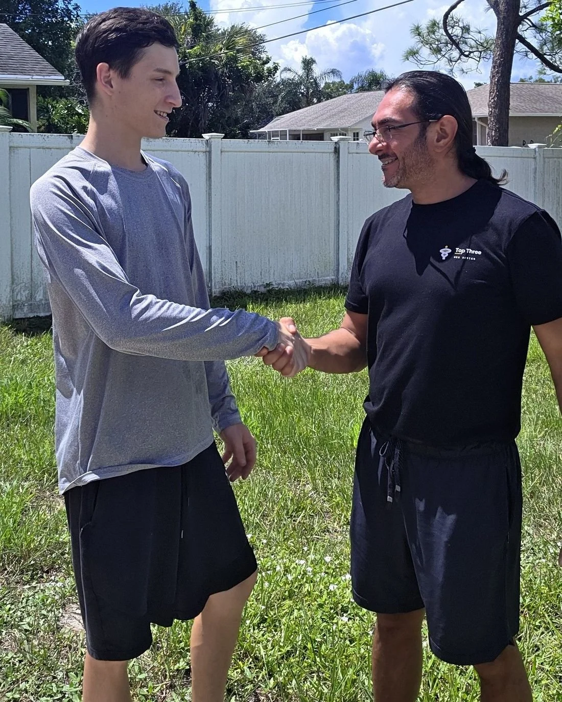 Dennis Aguilar of Top Three Web Design shaking hands with a client in Sebastian, Florida