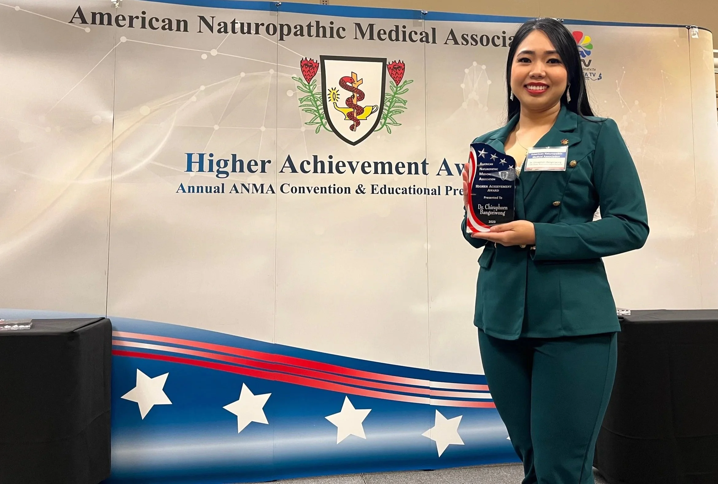 Dr. Chira receiving the Higher Achievement Award from the American Naturopathic Medical Association.
