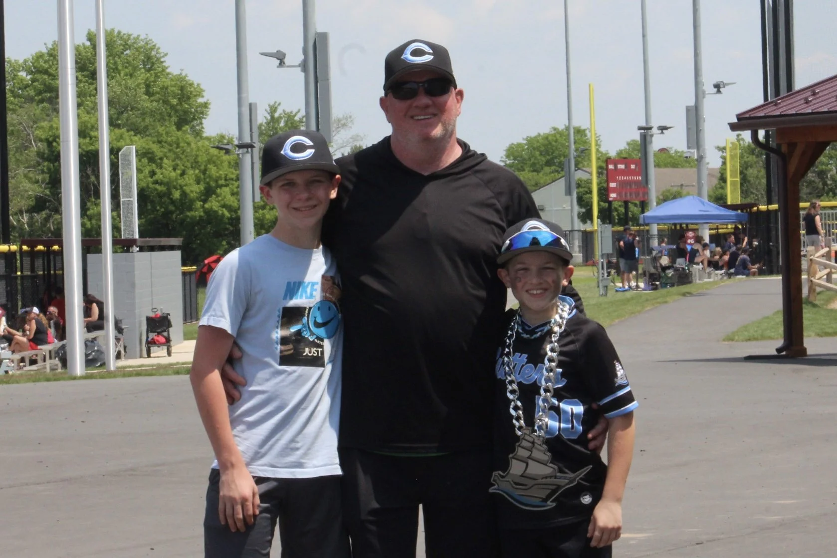Coach Archie Bowen with young baseball players at the ball field.
