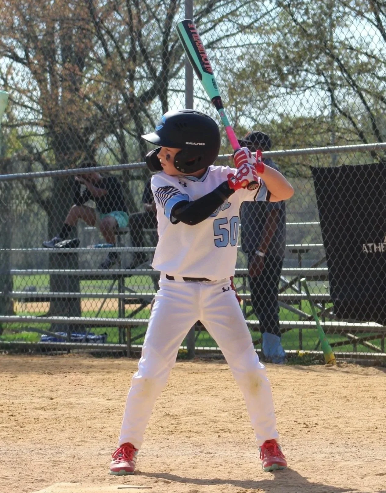 Youth baseball player hitting during a game, representing baseball hitting instruction and player development in Southern Maryland.