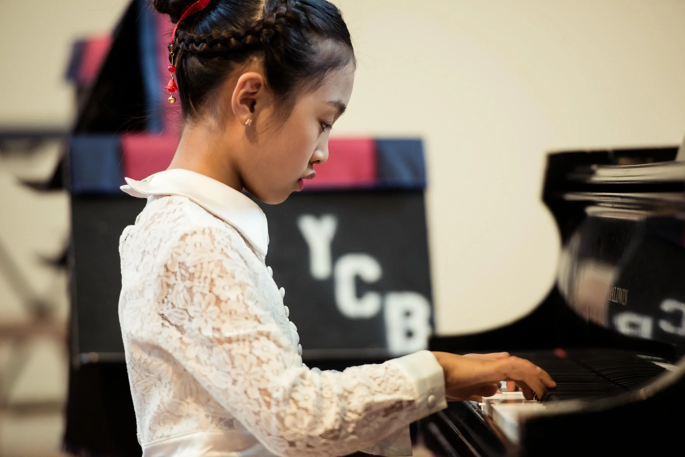 Young piano student performing at a recital